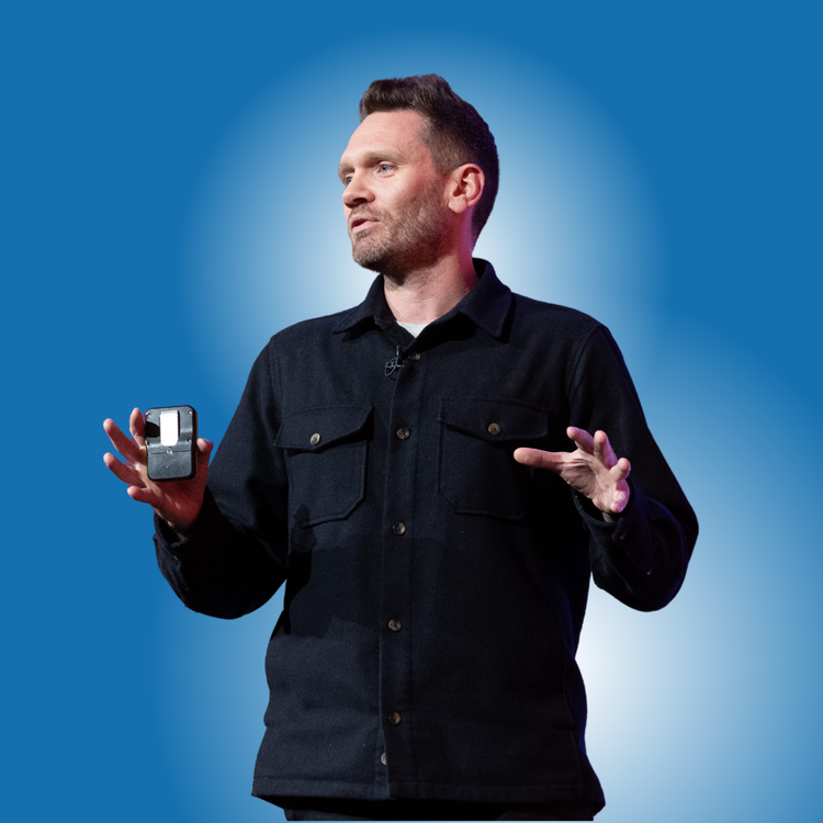 Dean Leak speaking on stage at a conference