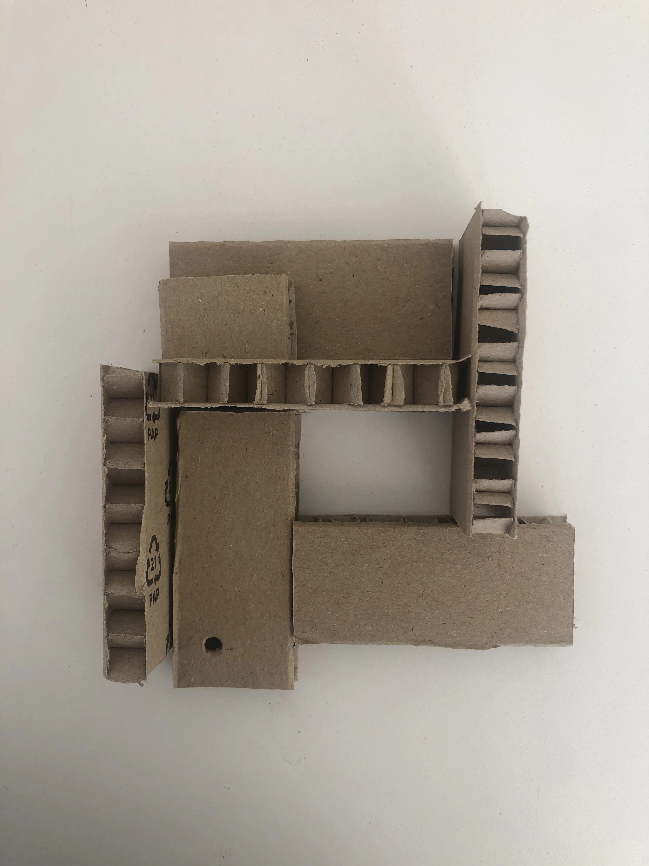 Six pieces plus one: Assembled object made from one piece of packaging cut into identical lengths plus one leftover pieces.

Approx. 6”x6”