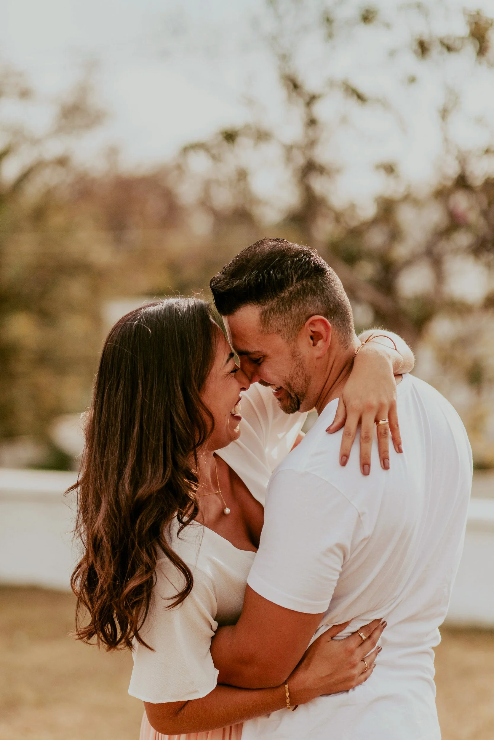 a joyful, laughing couple embraces each other