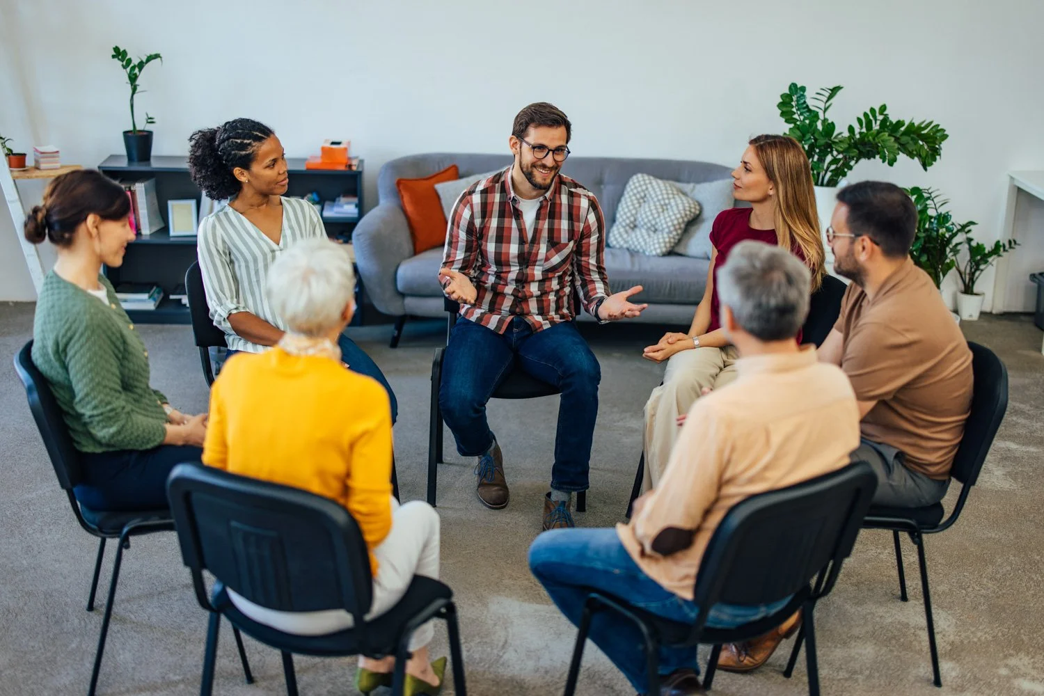 a group of participants the ROOTS IOP program at Kentucky Services discuss while sitting on a chairs in a circle
