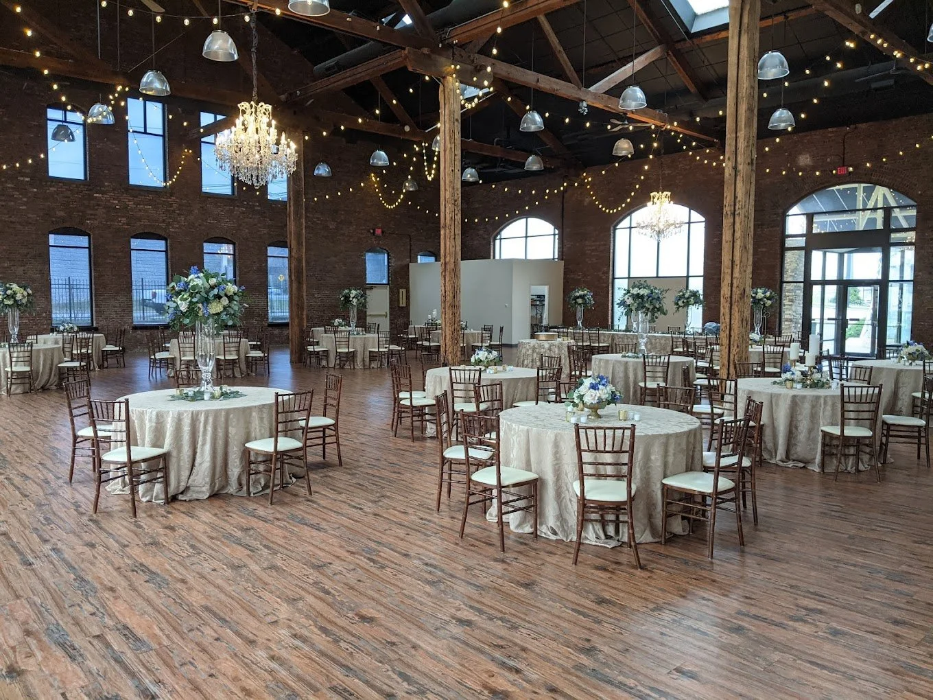 Refinery South Reception Open Floor Plan with 8 top tables and centerpieces