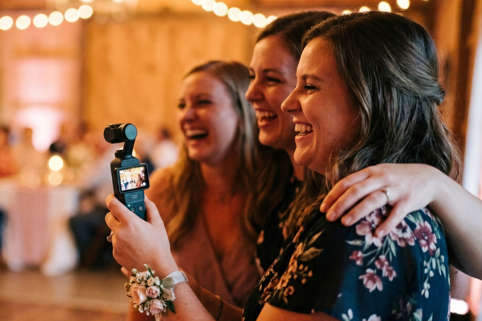 Three friends filming a reception