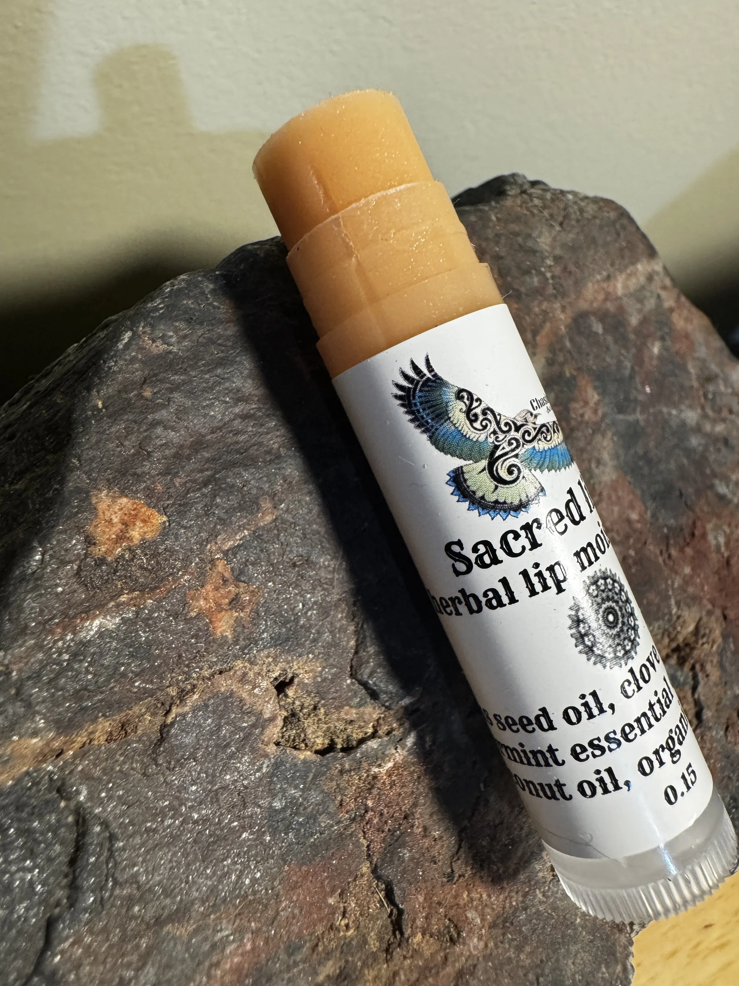 Clove lip balm for website on rock.JPG