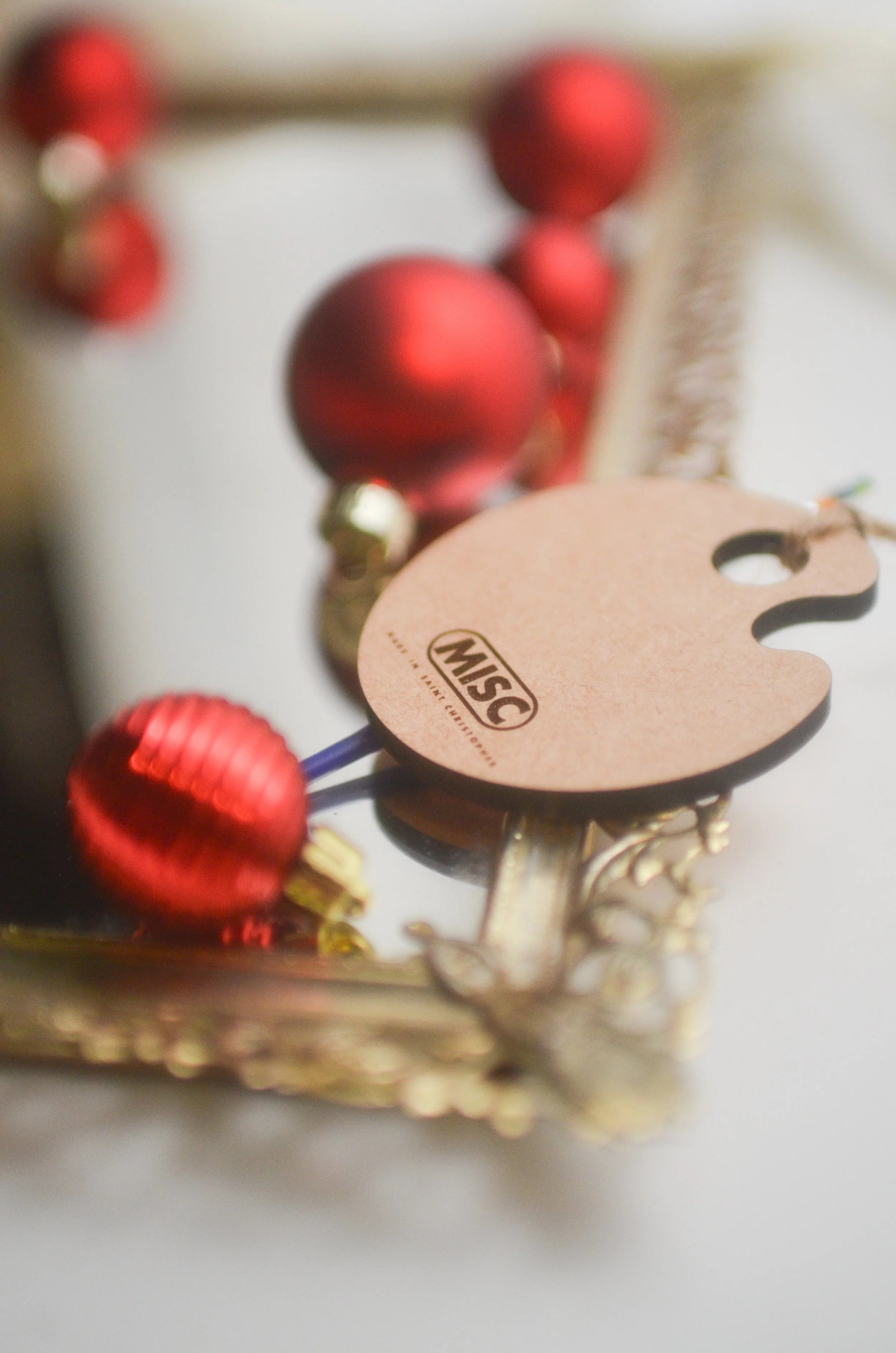Laser engraved logo detail on the back of our paint palette ornament.