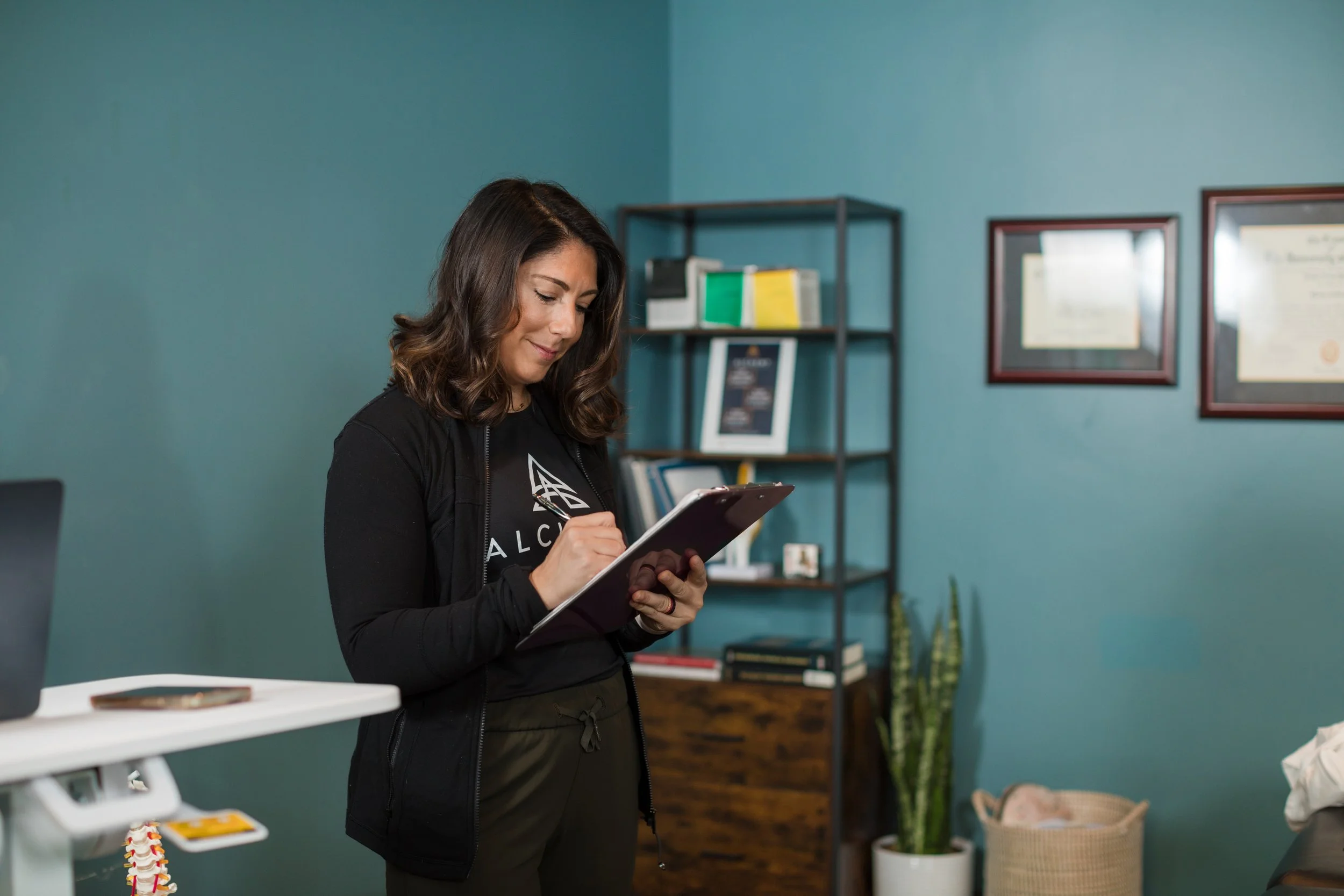 Deanna writing on a clipboard