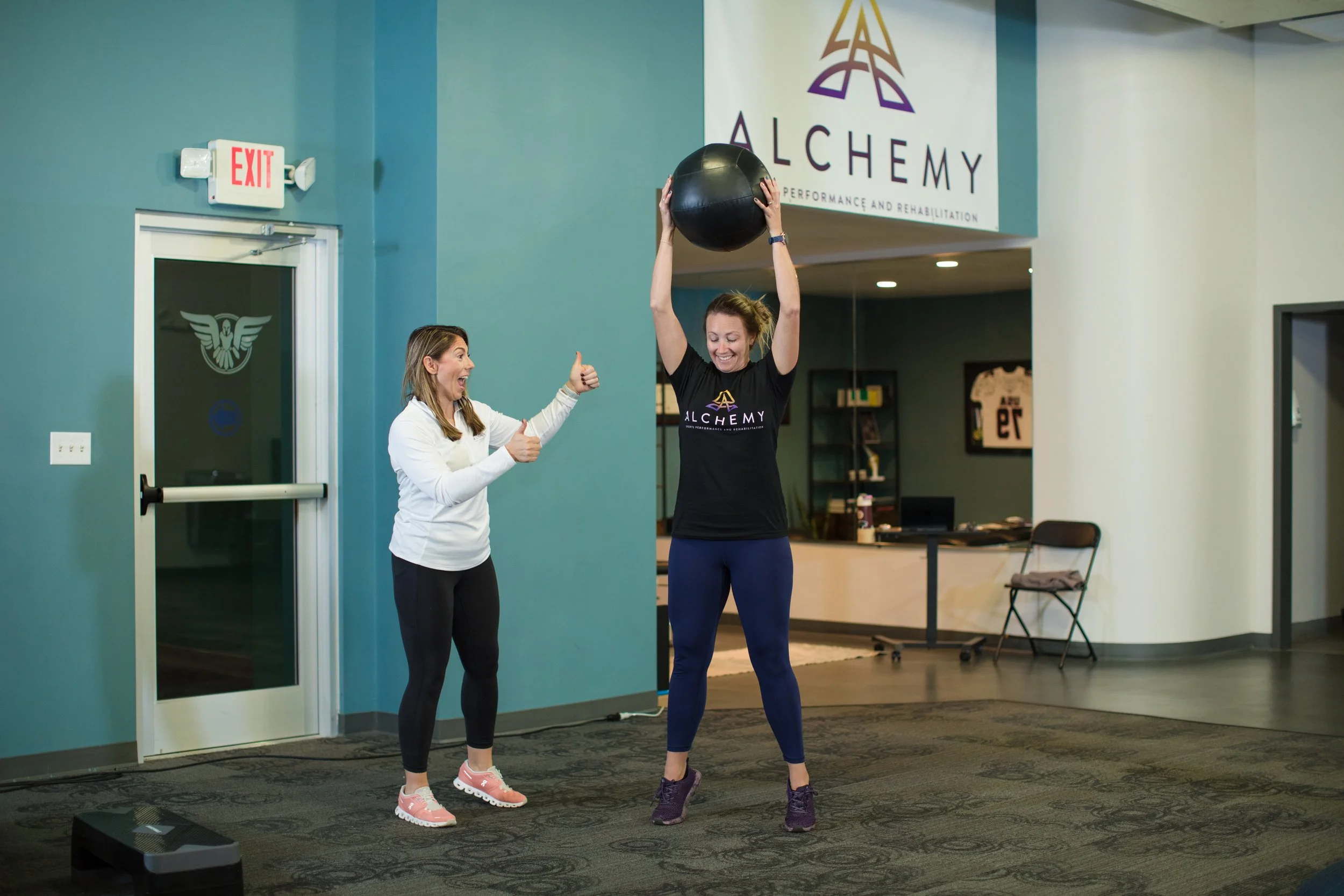 Woman throwing medicine ball to the ground