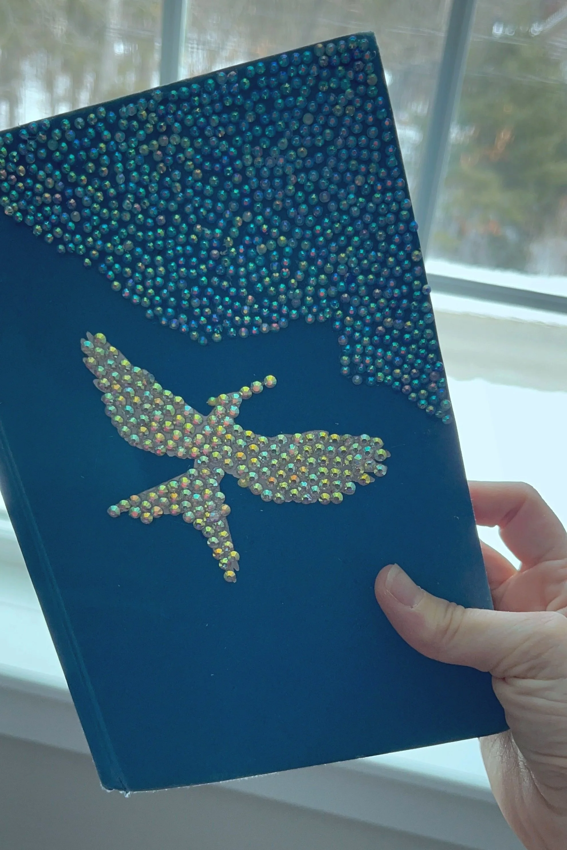 bedazzle book with gemstones in shape of bird and corner of book (Copy)