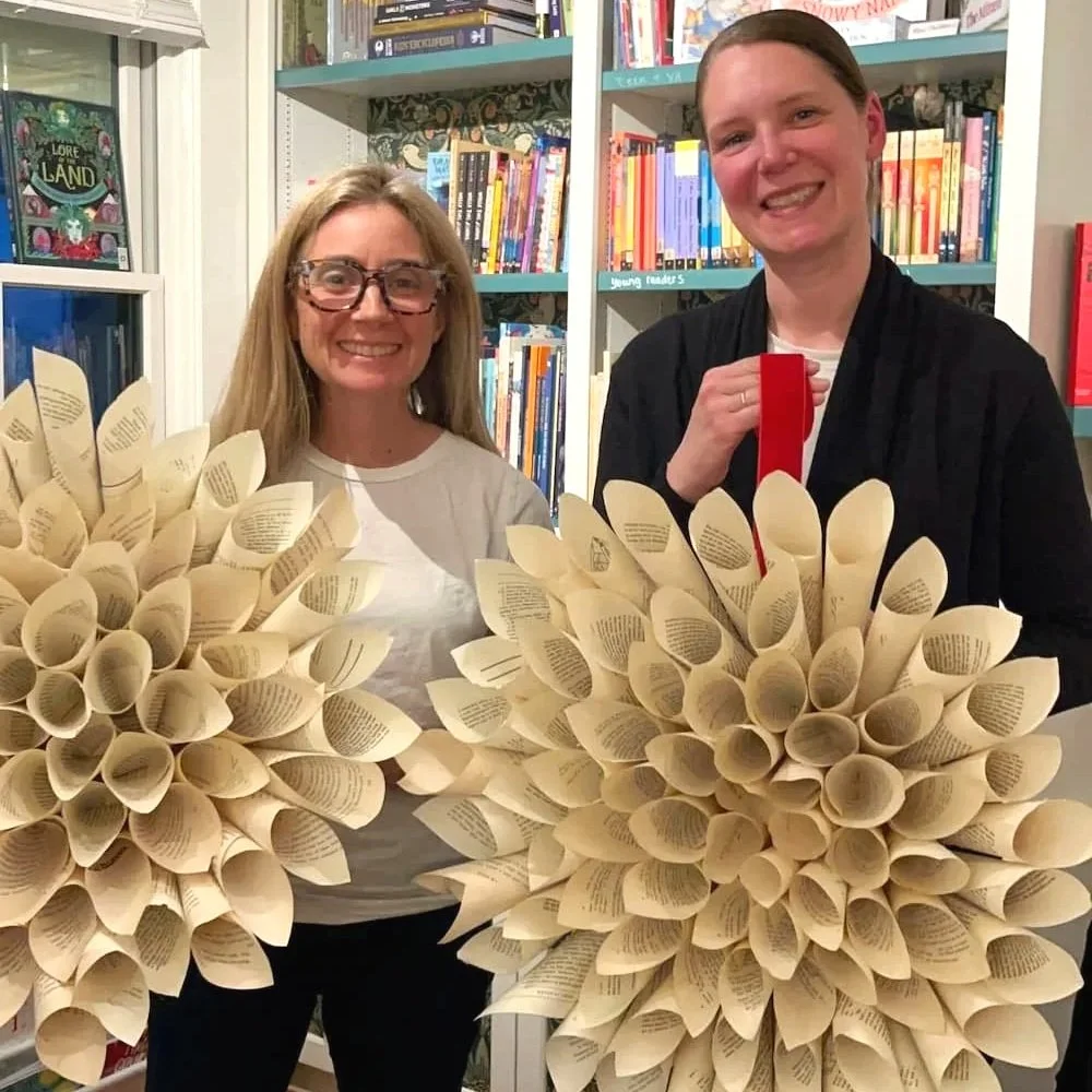 two people holding 3d dahlia paper wreath diy with slow craft llc in bedford ma