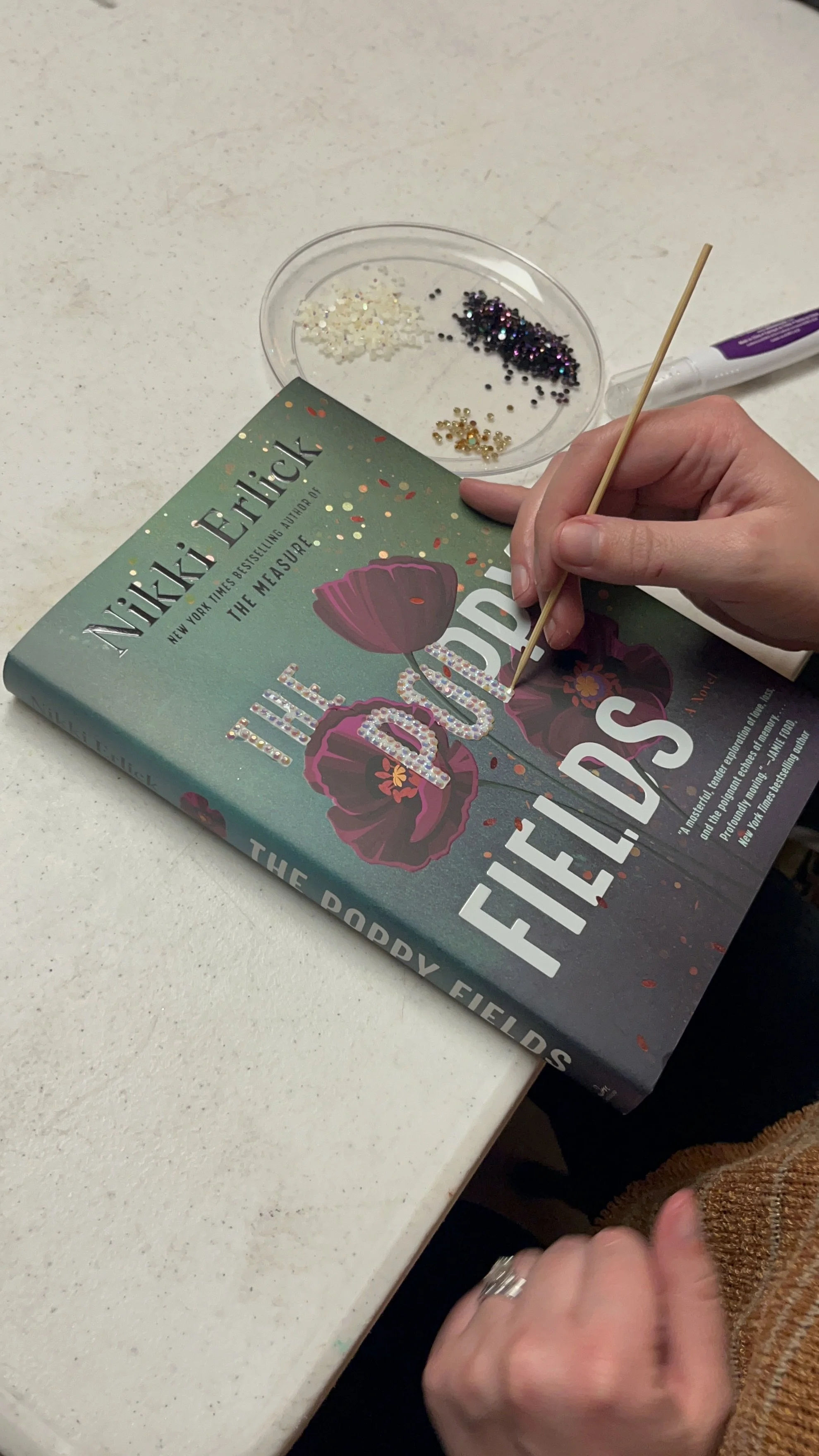bedazzled book cover with gemstones using hand tool