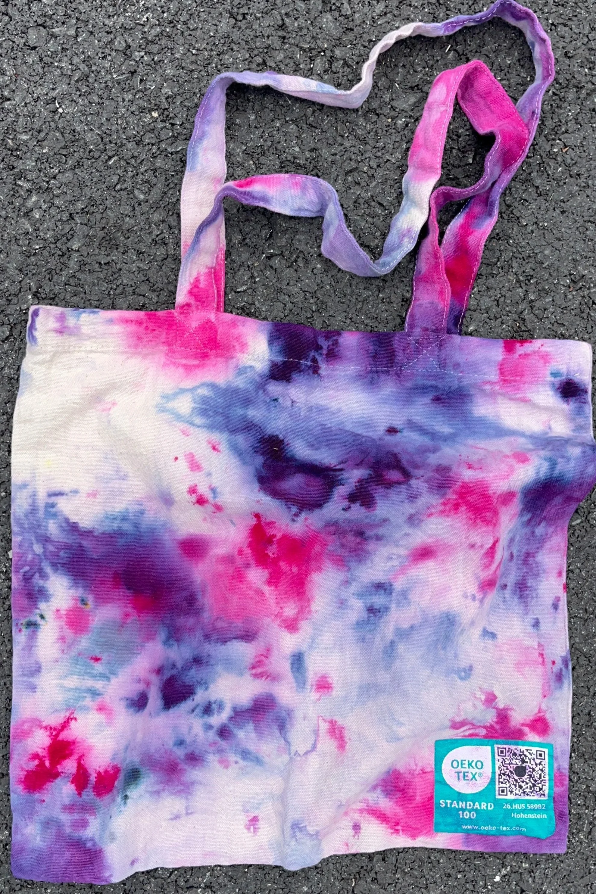 ice dye purple pink tote bag sitting on ground outside