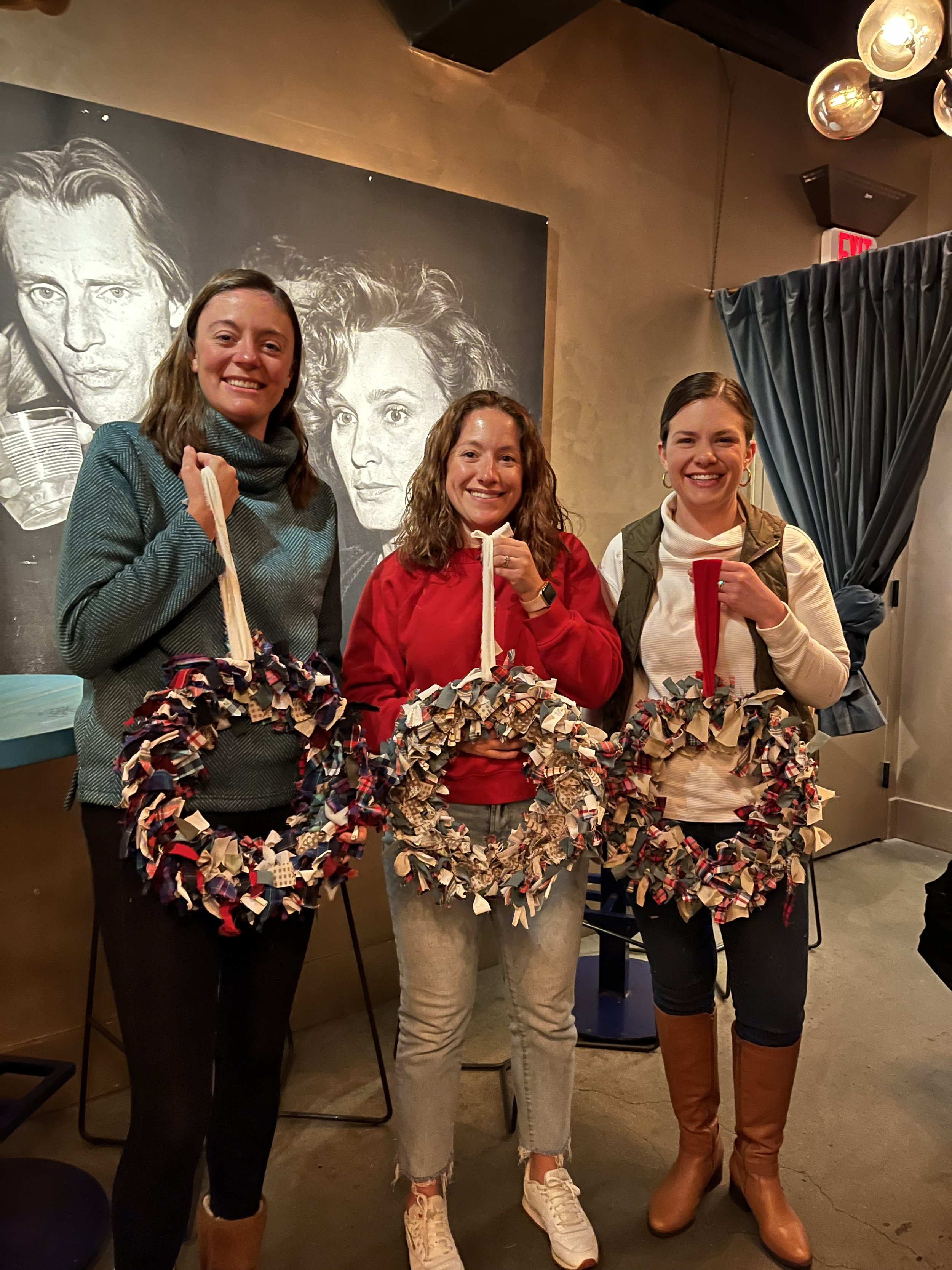 holiday wreaths holding three wreaths up
