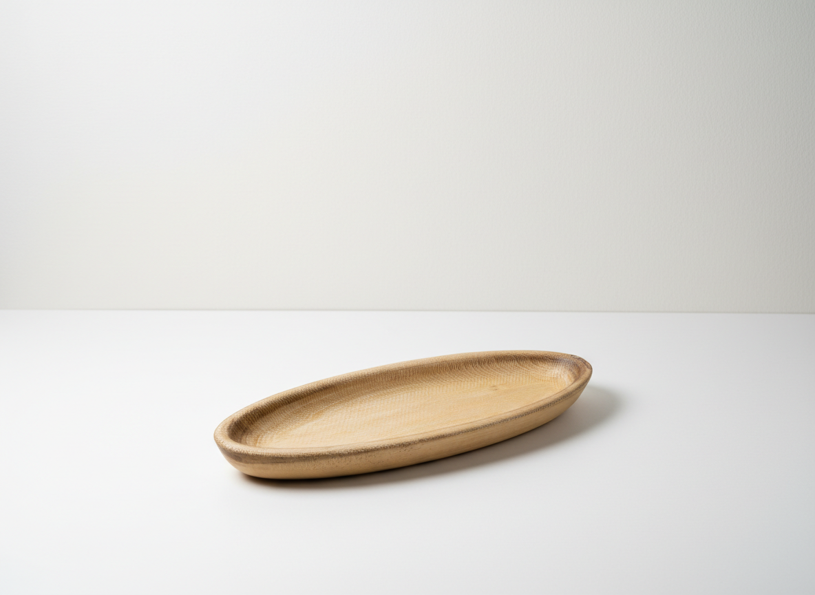 Empty wooden oval plate on a white surface with a minimalist background.