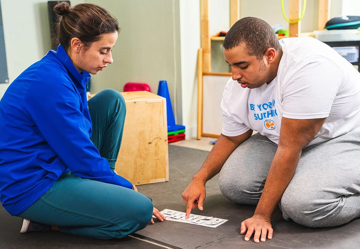 Kristen working with student at adaptive fitness