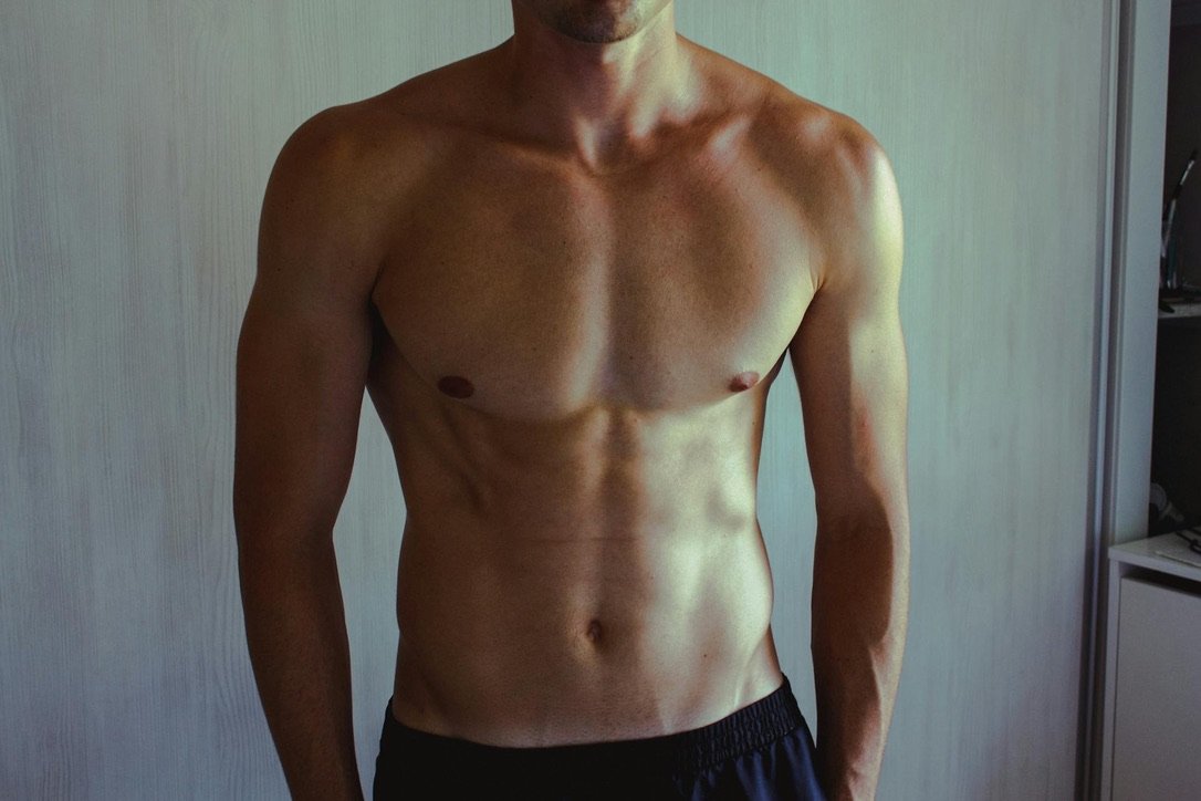 Lean, flat male chest, the result patients work toward during male breast reduction recovery in Denver at Amavi Aesthetic Surgery