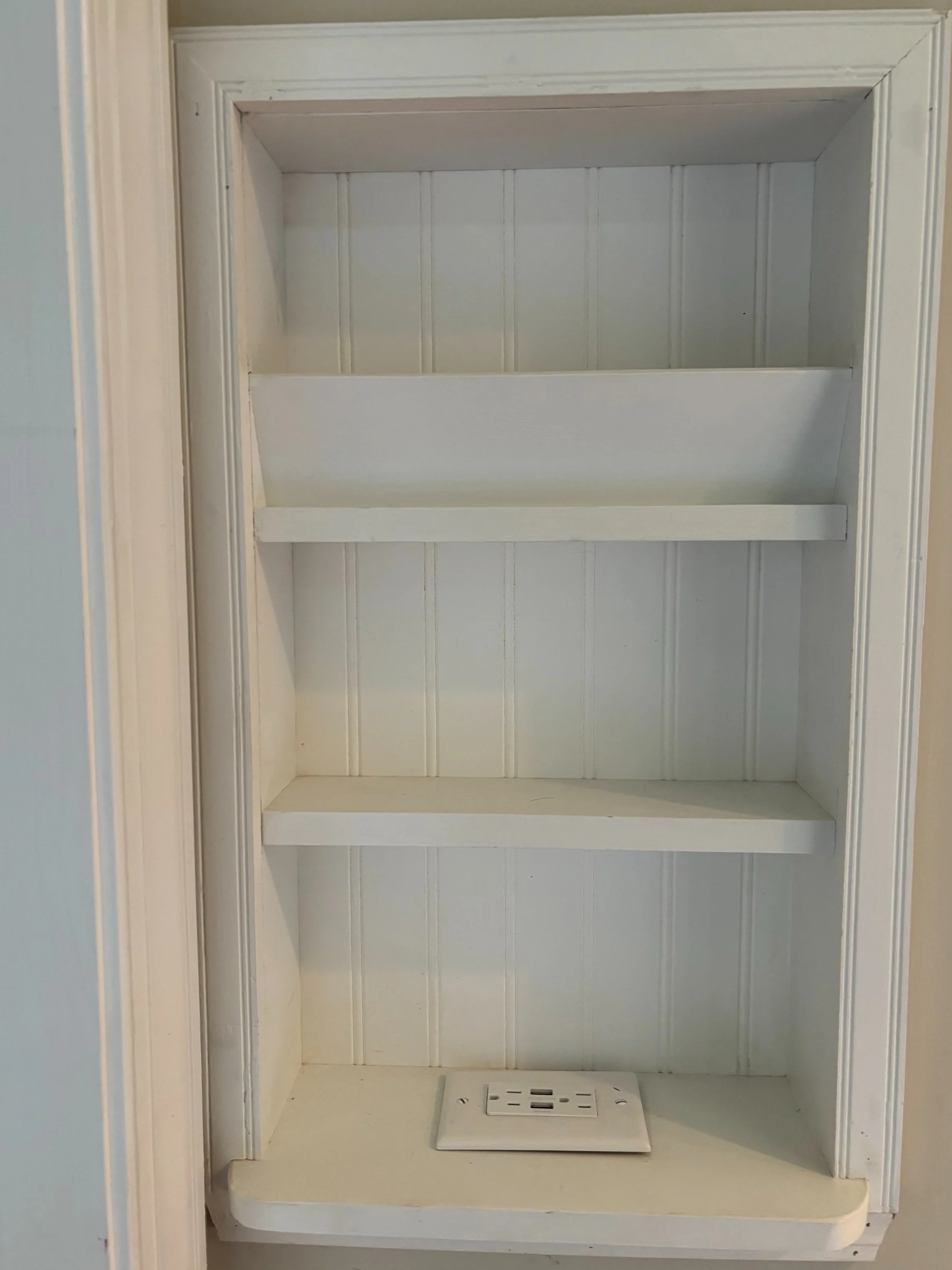 Builtin wall shelf with phone charger.jpg