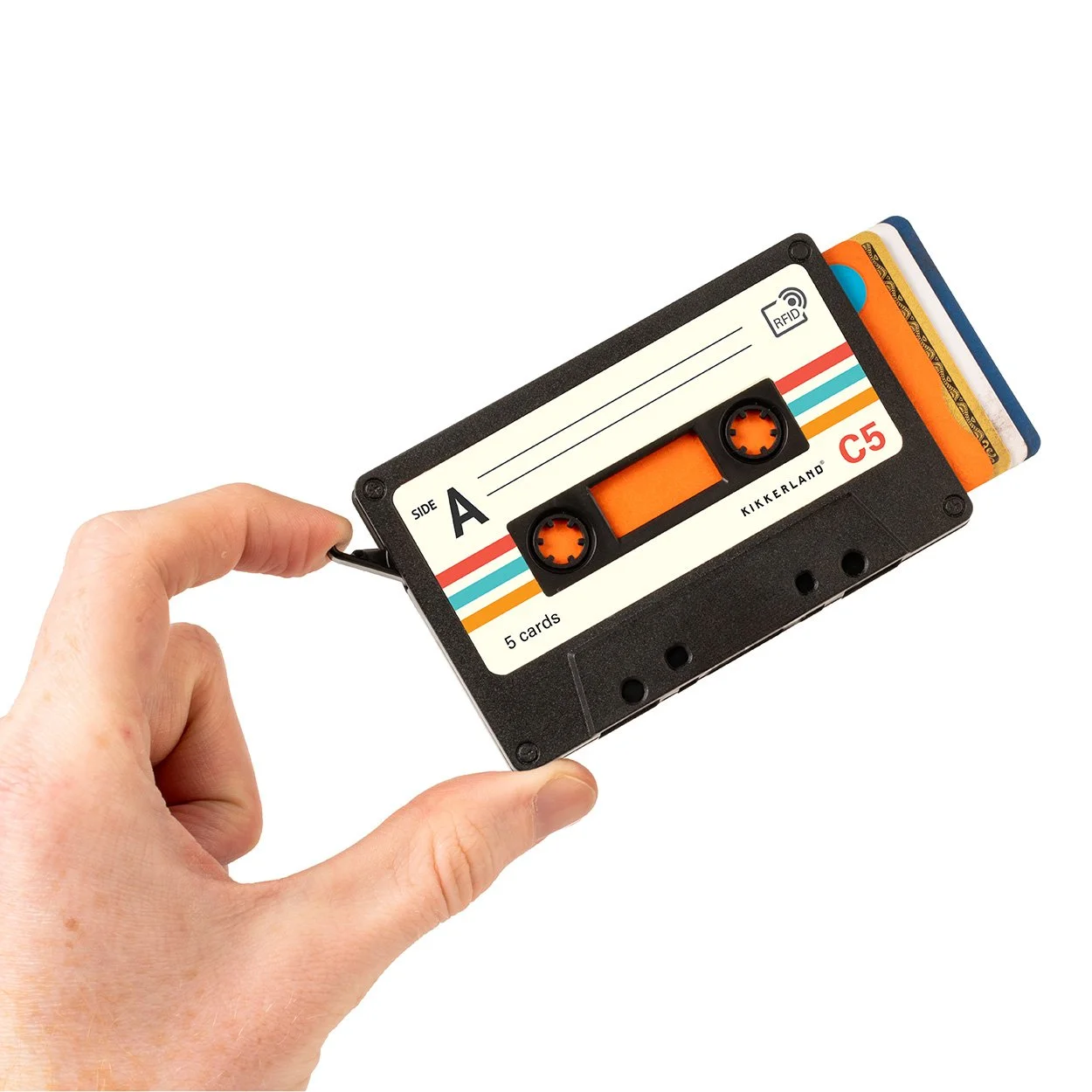 Hand holding black cassette tape card holder with credit cards fanned out on white background