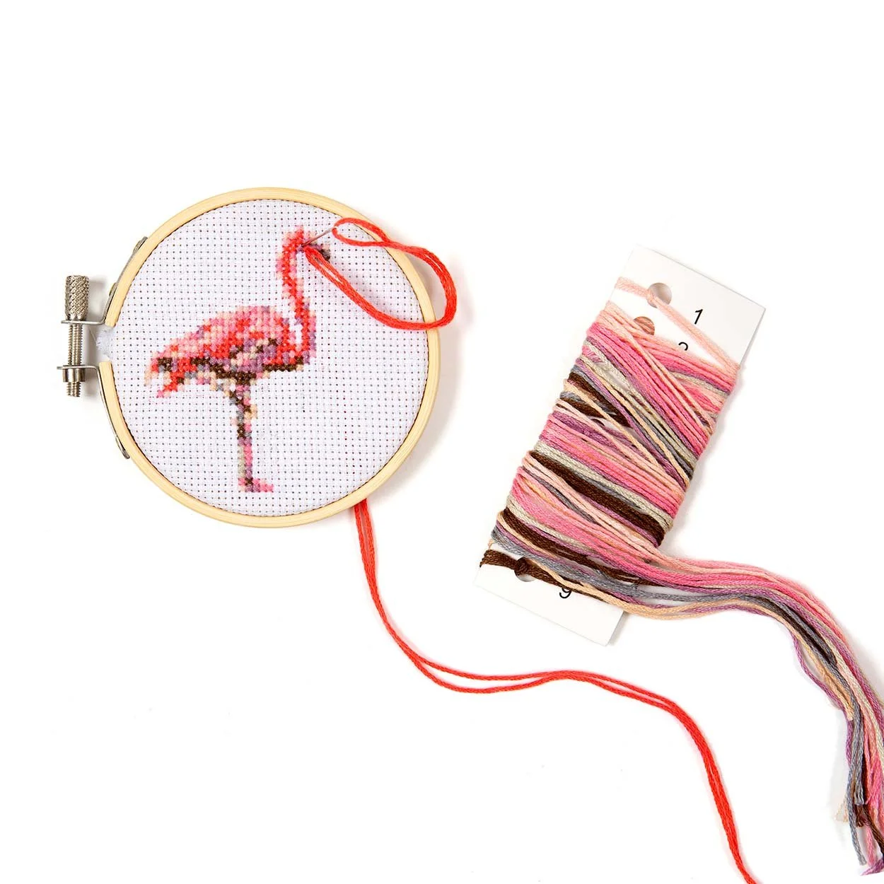 Mini flamingo cross stitch in bamboo hoop with color thread card on white background