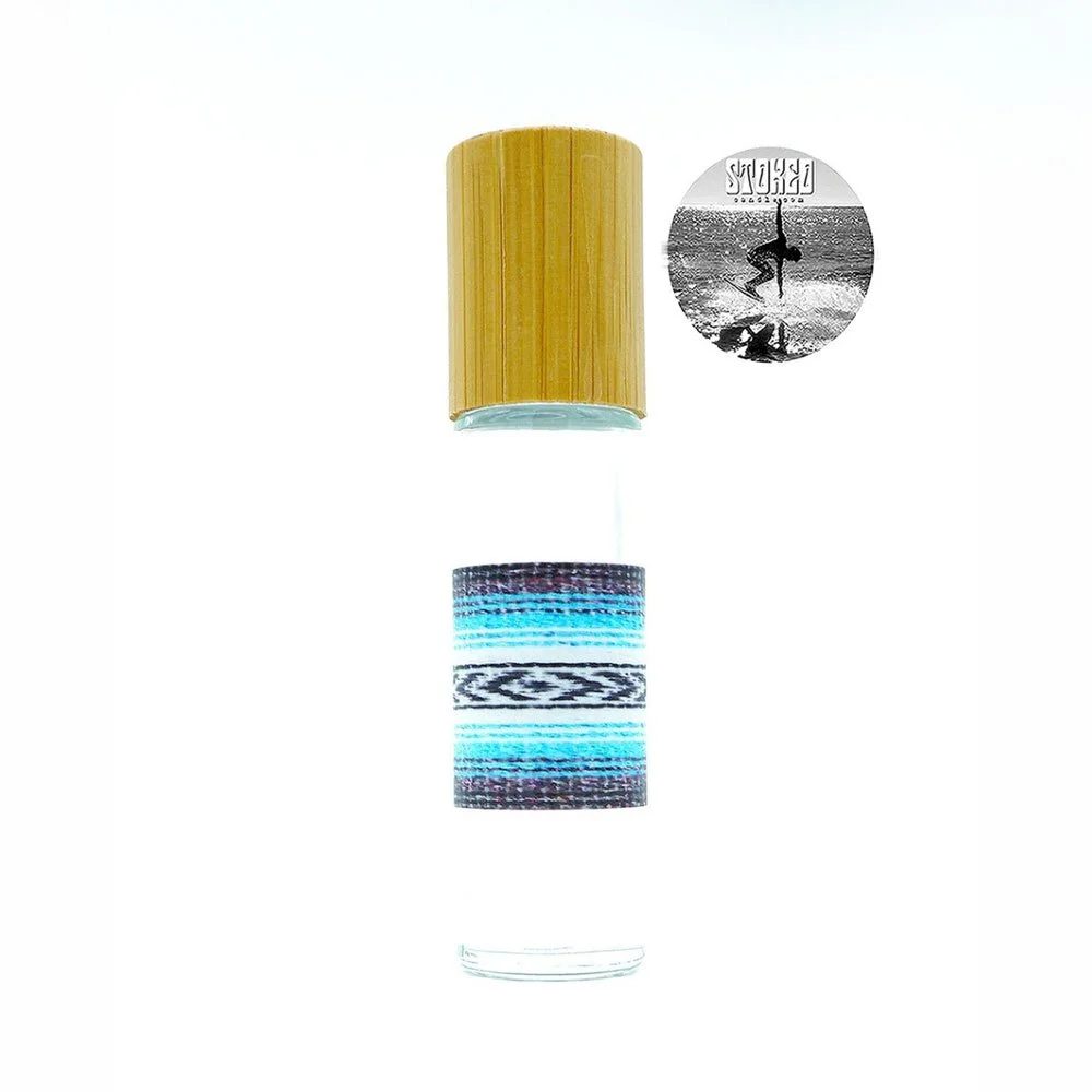 Stoked Rollie 10ml recycled glass rollerball body oil bottle with baja blanket print label and bamboo cap on white background