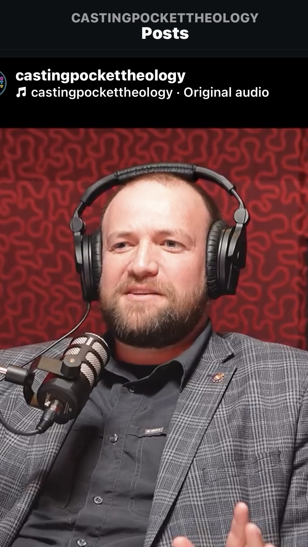 A man with a beard and short hair speaking into a microphone during a recording, wearing headphones, and dressed in a gray checkered blazer and a dark shirt. The background features a red patterned wall and a black banner with the text 'CASTINGPOCKETTHEOLOGY Posts' and 'castingpockettheology · Original audio'.