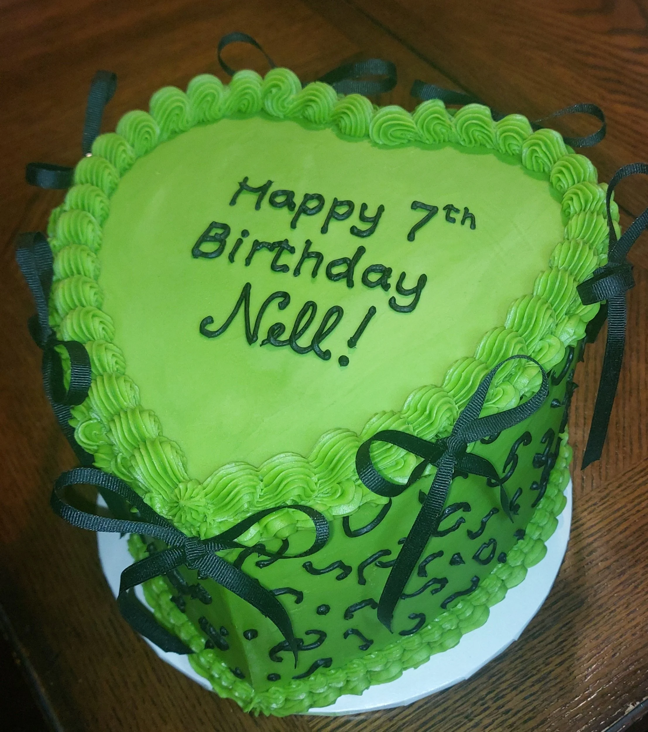 Lime green heart cake with black bows and cheetah pattern