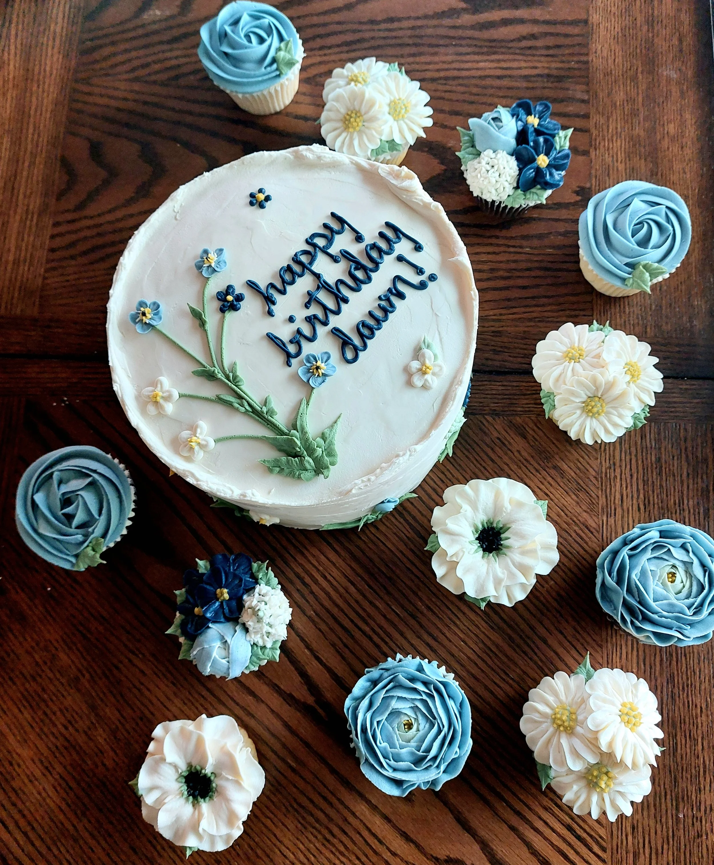 Small cake with coordinating cupcakes
