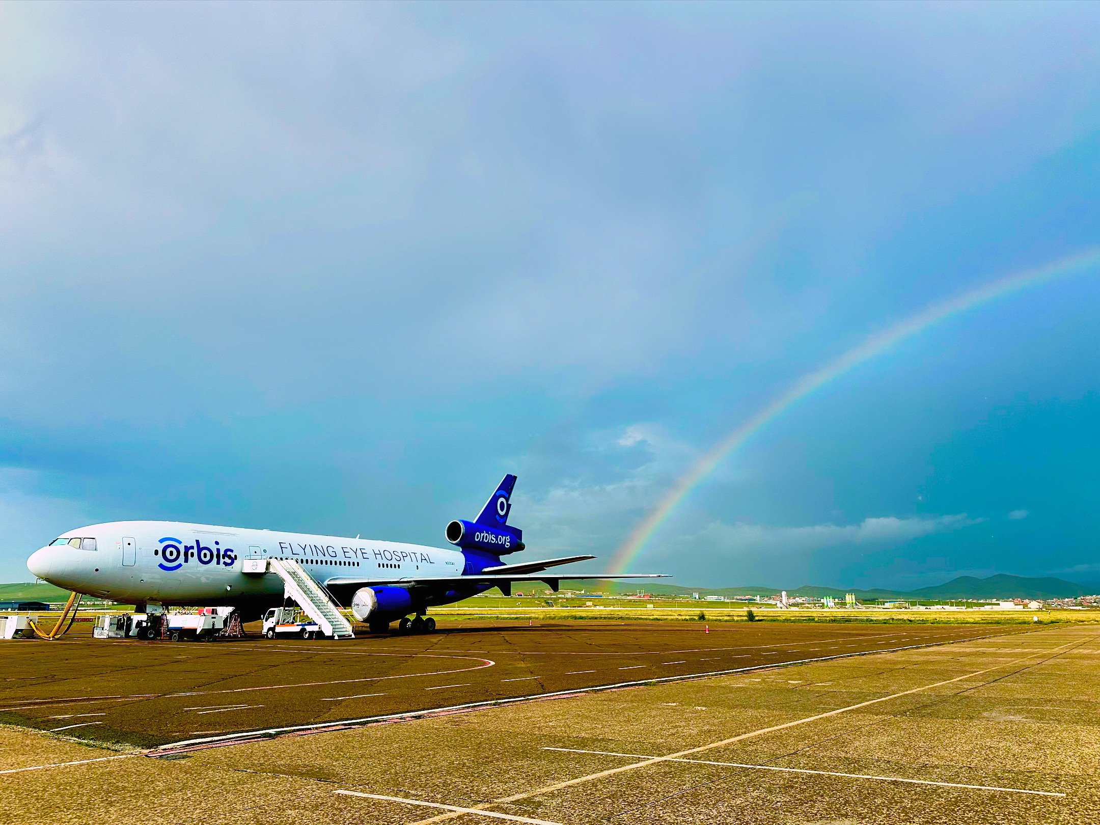 Plane with rainbow in background
