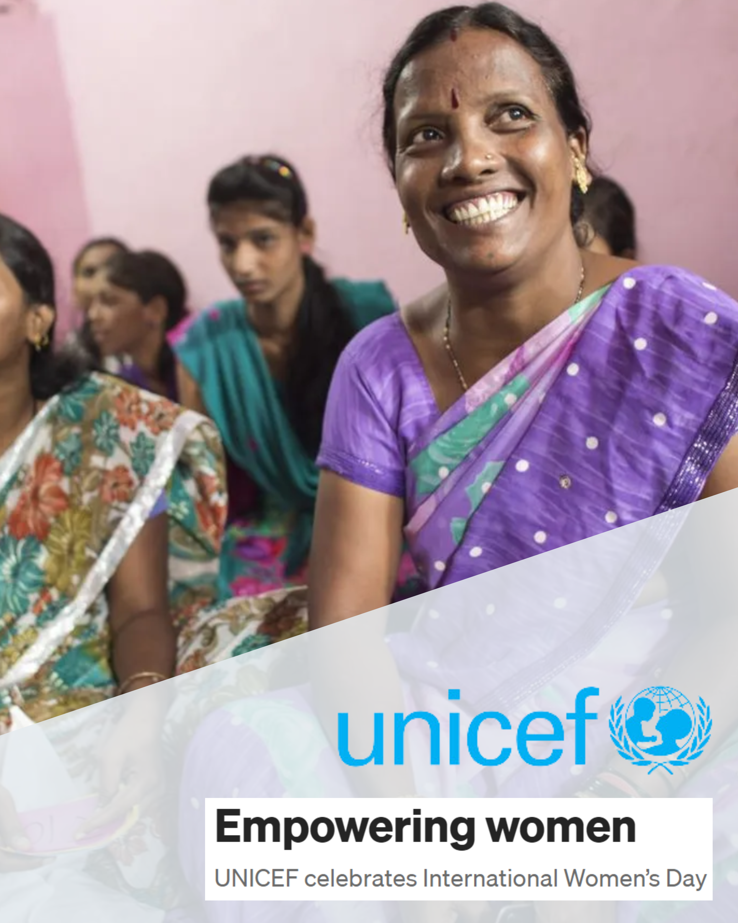 A smiling Indian woman wearing a bindi and purple sari sits with a group of other Indian women wearing saris behind her. Atop the image is the UNICEF logo and the text "Empowering women: UNICEF celebrates International Women's Day"