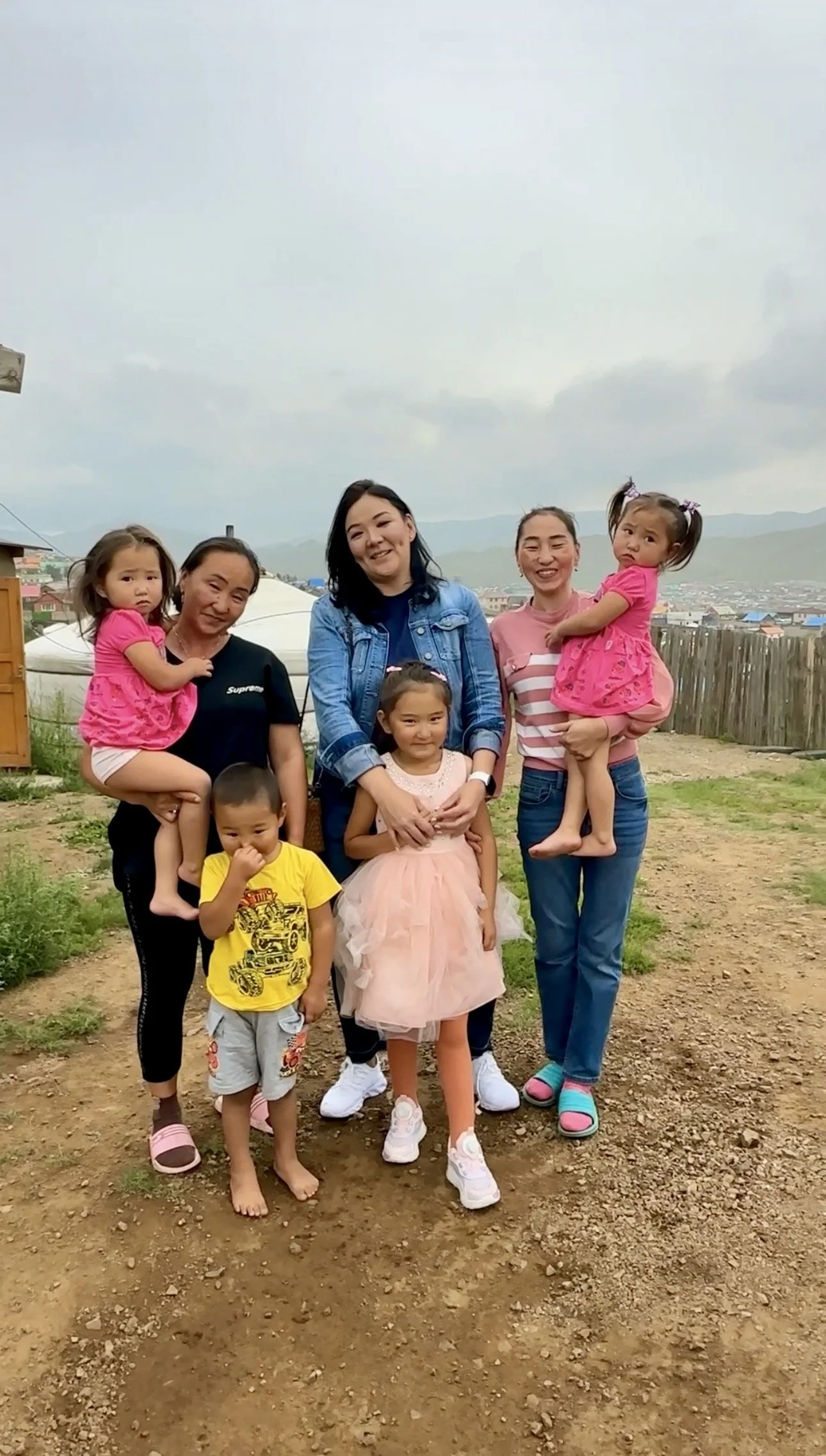 Bulgan smiles with a young patient and her family