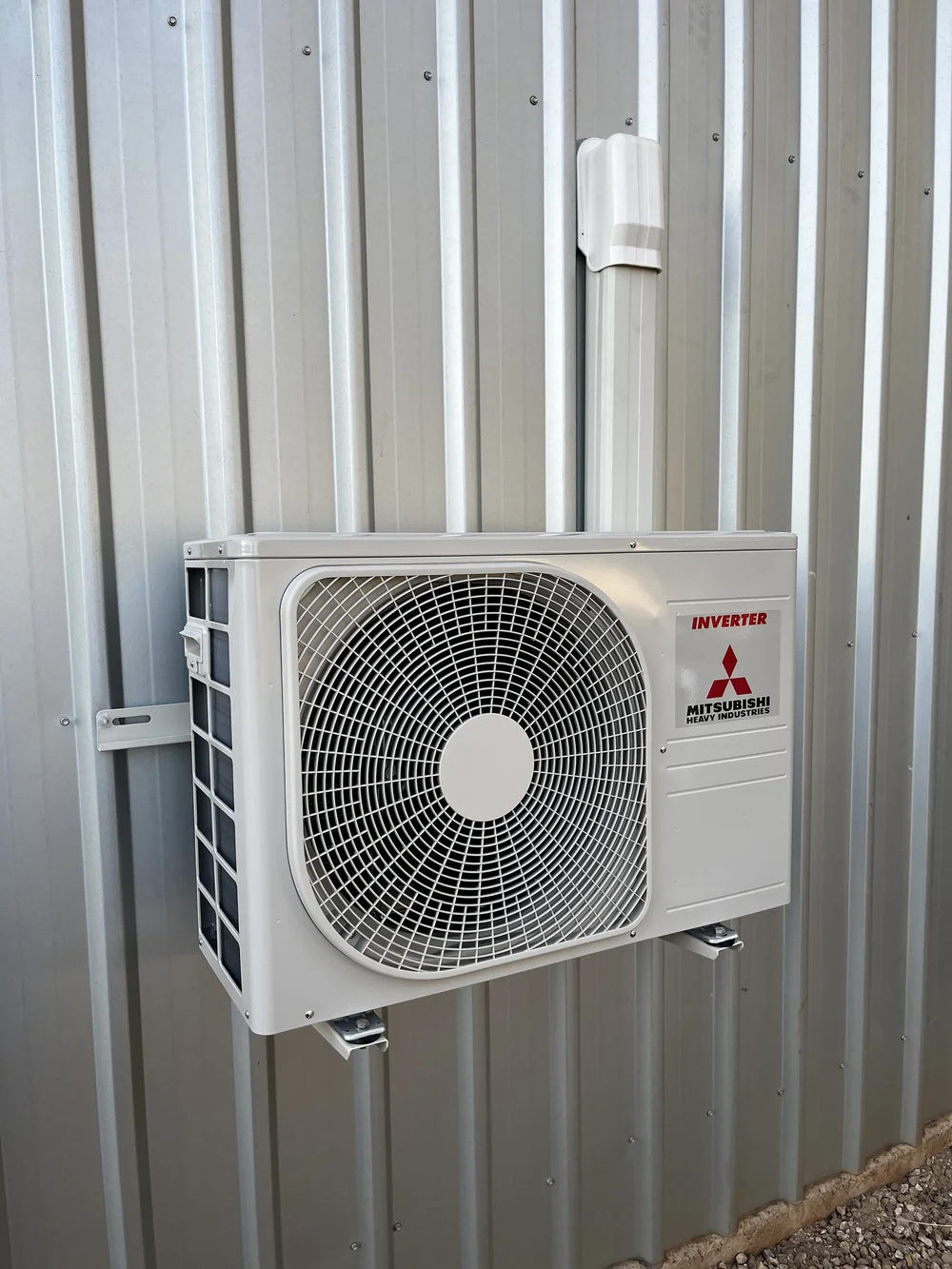 Mitsubishi Heavy Industries outdoor unit mounted on a wall bracket