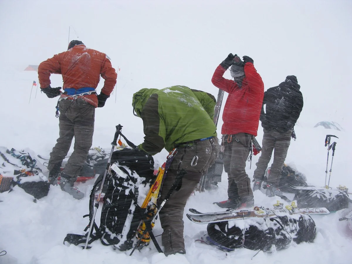 We left the 11,000-foot camp at about 11:30pm in rather horrible conditions with near-zero visibility and between one and two feet of new snow depending on how the wind moved it around. We traveled from wand to wand, sometimes missing them, veering o