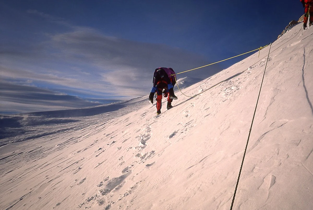 Alex Lowe (aka “The Lung with Legs”) carrying an injured Spaniard at 19,300’ on Denali, Alaska. A U.S. Army Chinook landed Alex, Scott Backes and I on the “Football Field” just below the summit to carry out the rescue. In doing so pilot Bill Barker s