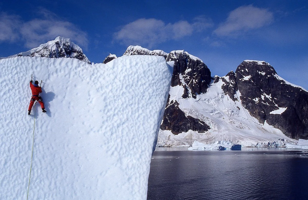 February 1997: There’s no instruction manual for climbing icebergs. We thought it might be better to solo wearing a life jacket, but hitting water from a hundred feet would be like decking anywhere. Because we used the rope, we carried knives to cut