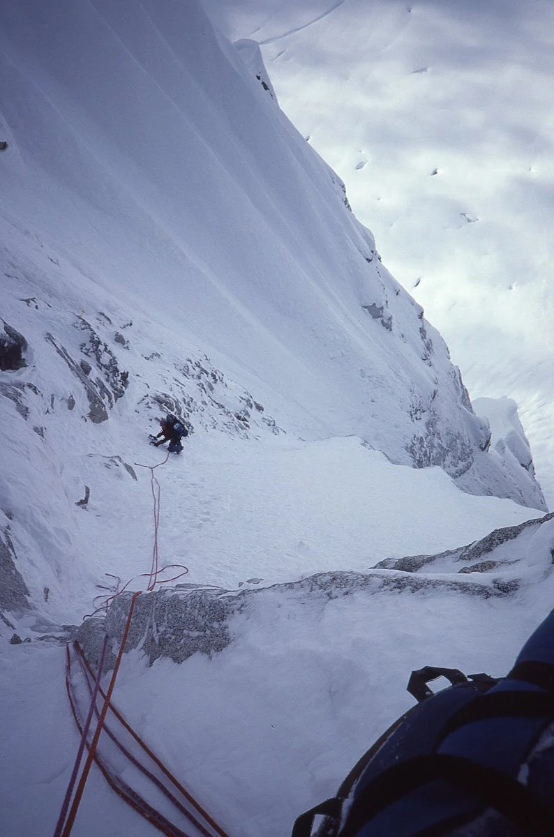 April 1985: Many pitches up the Colton-Leach route on the north buttress of the Rooster Comb in Alaska. We climbed 16 pitches the first day, had a splendid bivouac during which we were treated to an intense northern lights show. The second day didn’t