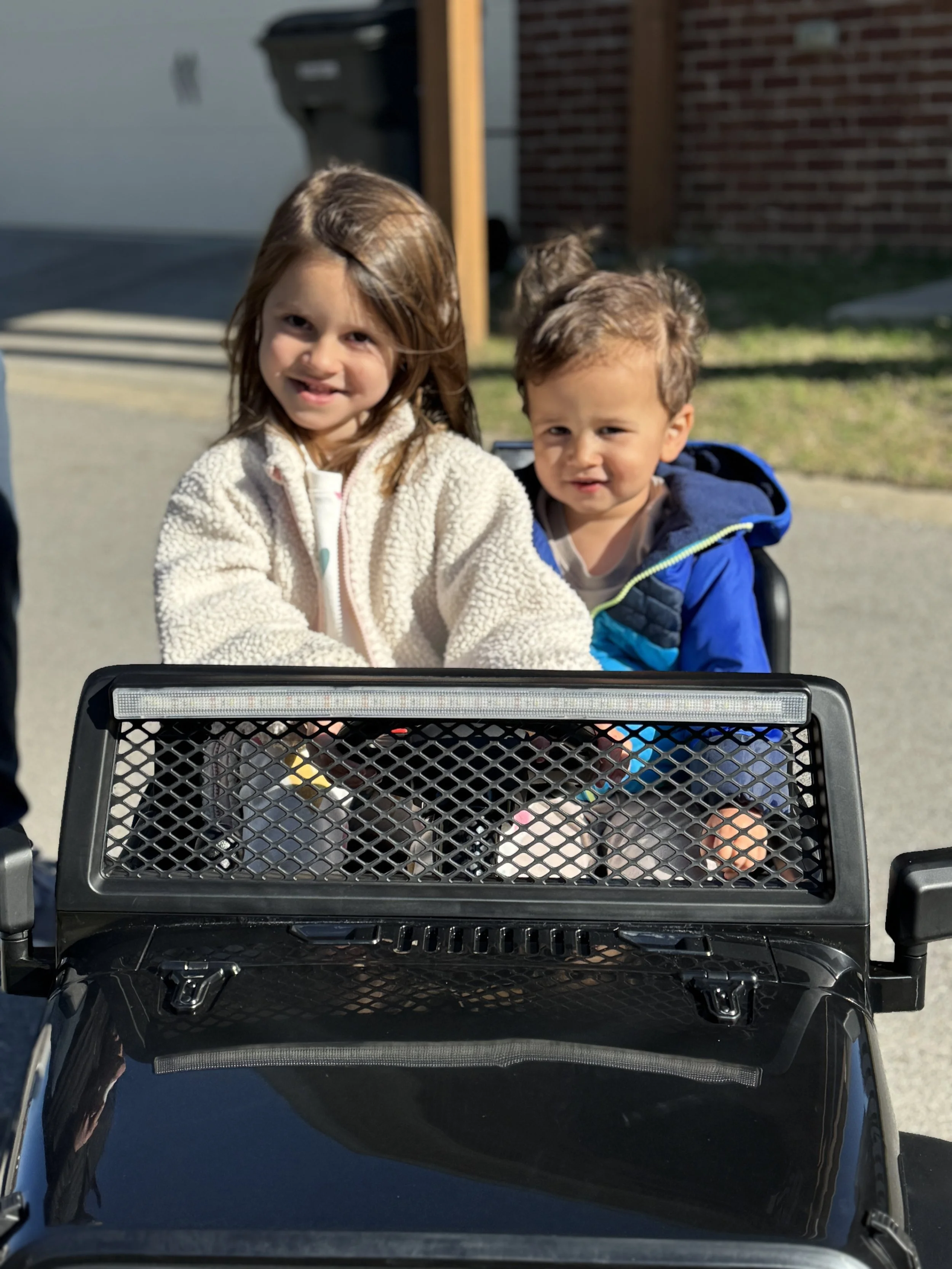 Big sister driving the jeep.