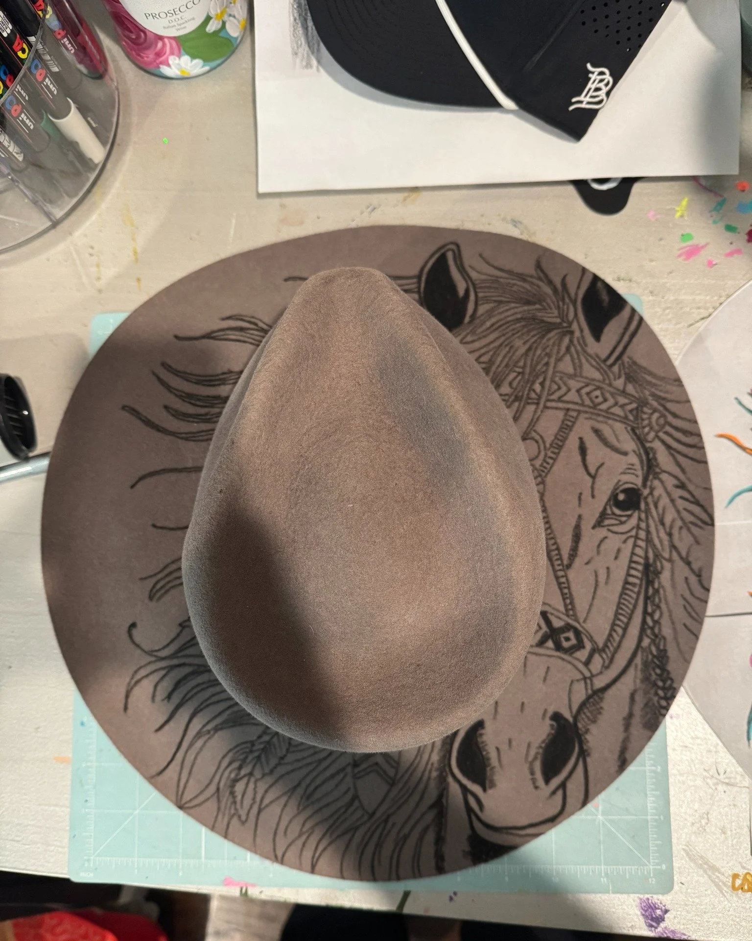 One of my favorite things about creating custom artwork is that sometimes people bring me ideas I never would have imagined on my own.

This one started with two horses, a barn friendship, and a vision. A fedora with a horse, flowing mane, a straw co