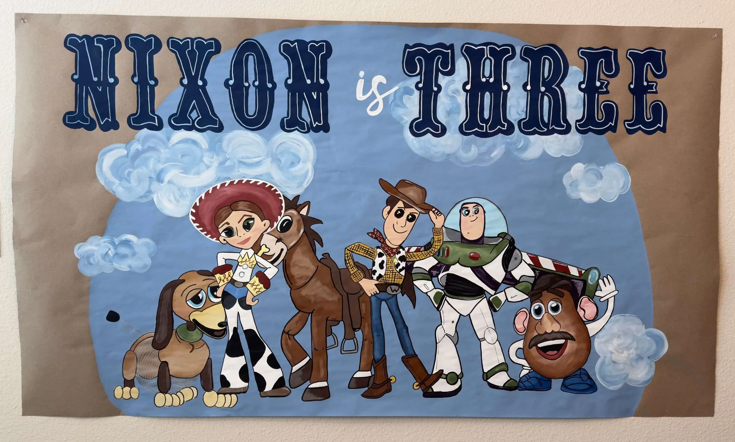 Colorful poster featuring characters from Toy Story with the text 'Nixon is there' and cartoon-style clouds in the background.