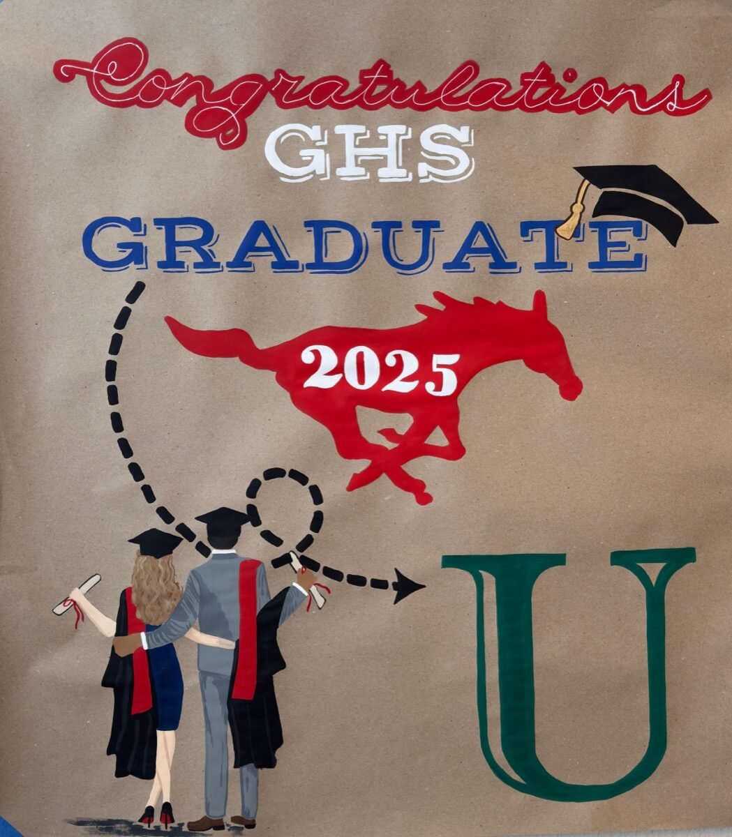 Hand-painted GHS Graduation 2025 banner with students and school logo.