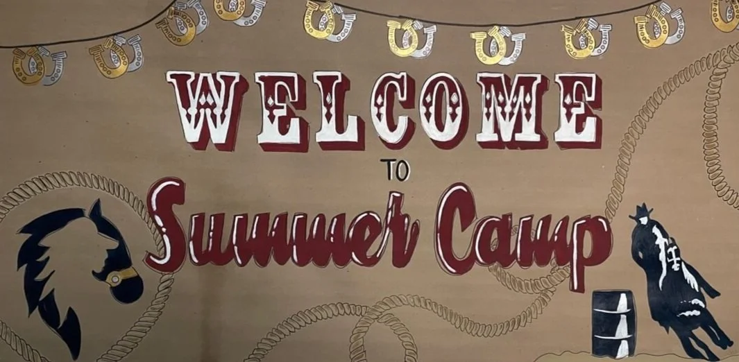 A "Welcome to Summer Camp" hand-painted banner, decorated with horseshoes and cowboy-themed illustrations.