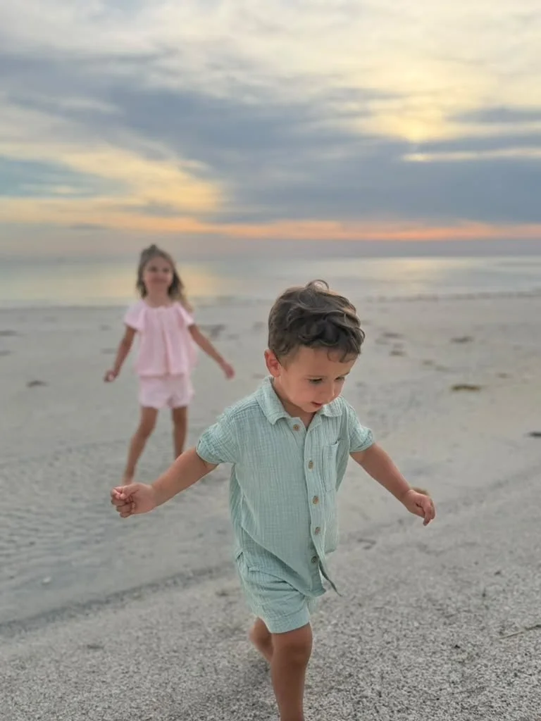 Young grandchildren enjoying the beach at Siesta Key during a family trip given as a meaningful Christmas experience gift.
