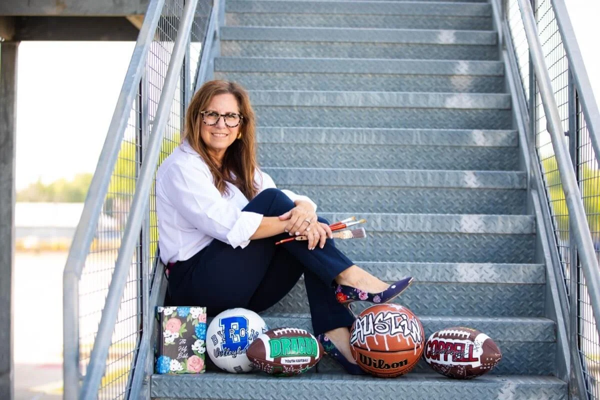 hand painted sports balls and bible on steps under artist