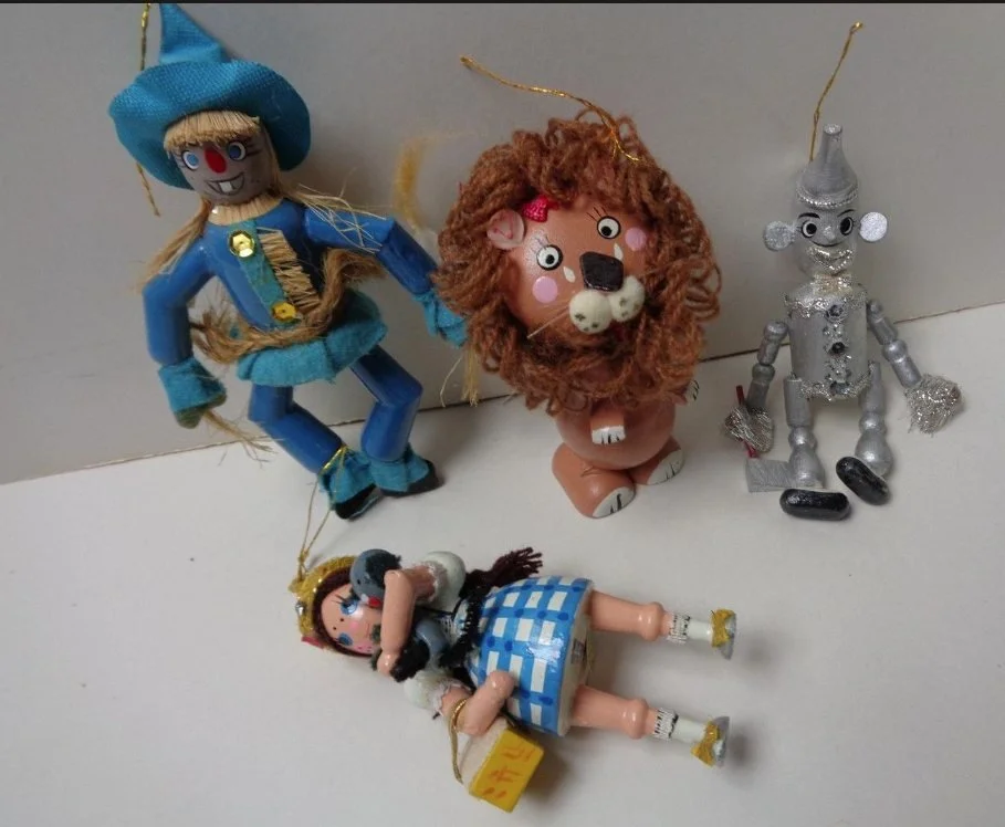 Vintage 1976 Wizard of Oz Christmas ornaments featuring the Scarecrow, Cowardly Lion, Tin Man, and Dorothy.