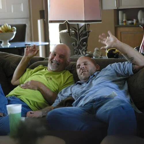 phil-john-smiling-waving-couch-photo.jpg