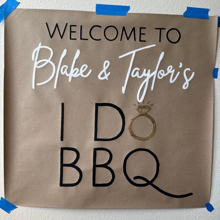 Hand-painted simple banner for Blake and Taylor's wedding celebration 'I Do BBQ'.