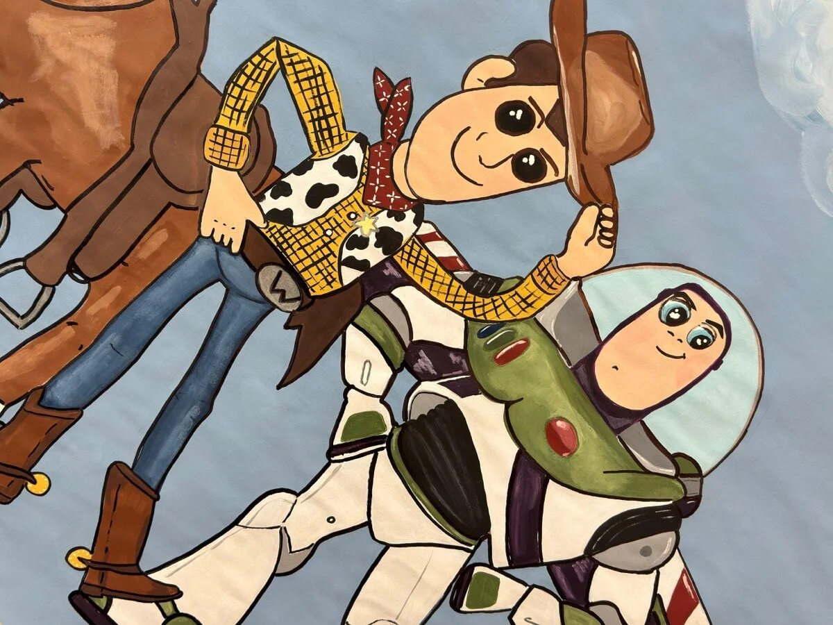 A close-up of a Toy Story-themed customizable banner featuring Woody and Buzz Lightyear in action poses.