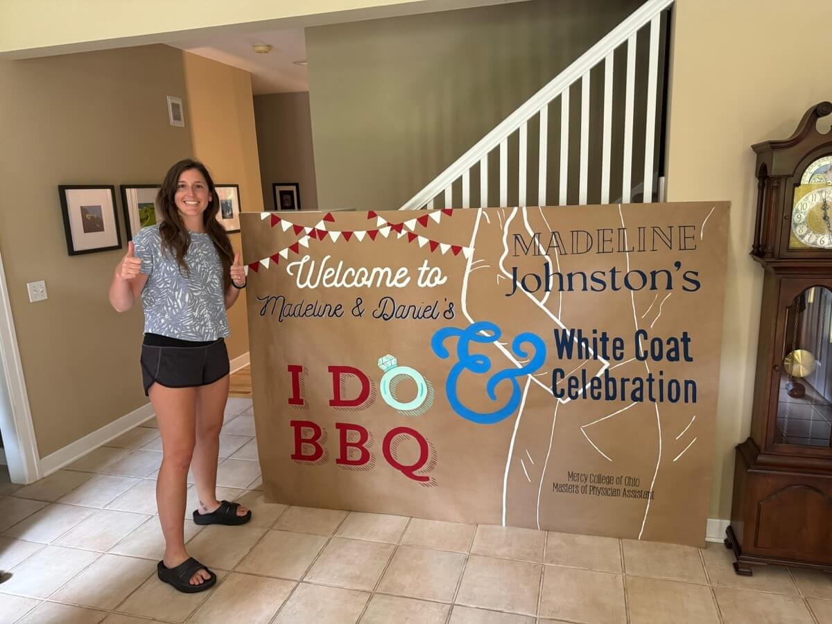 Custom hand-painted banner for Madeline Johnston’s white coat and "I Do BBQ" celebration.