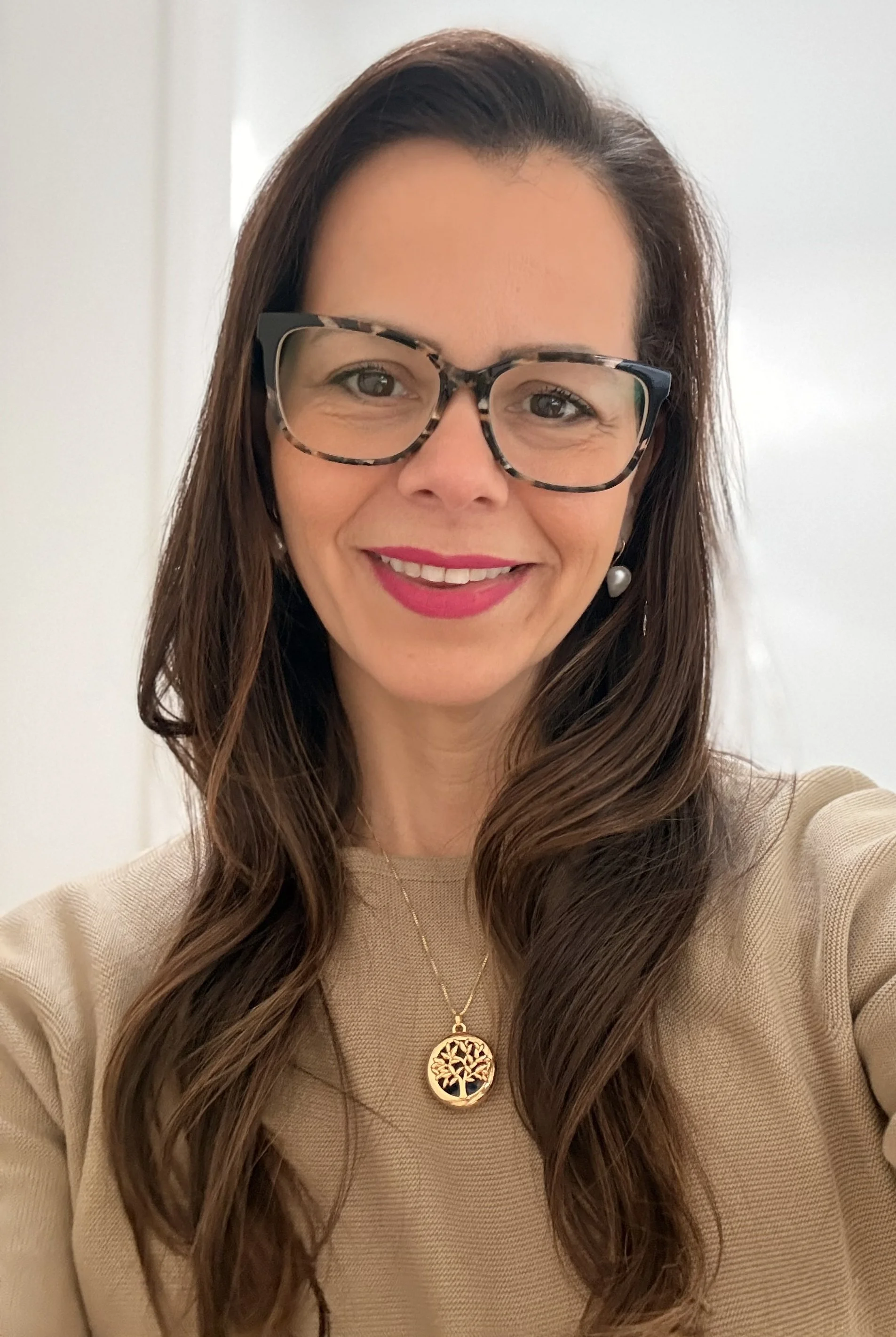 Fernandes is a woman with long brown hair and glasses