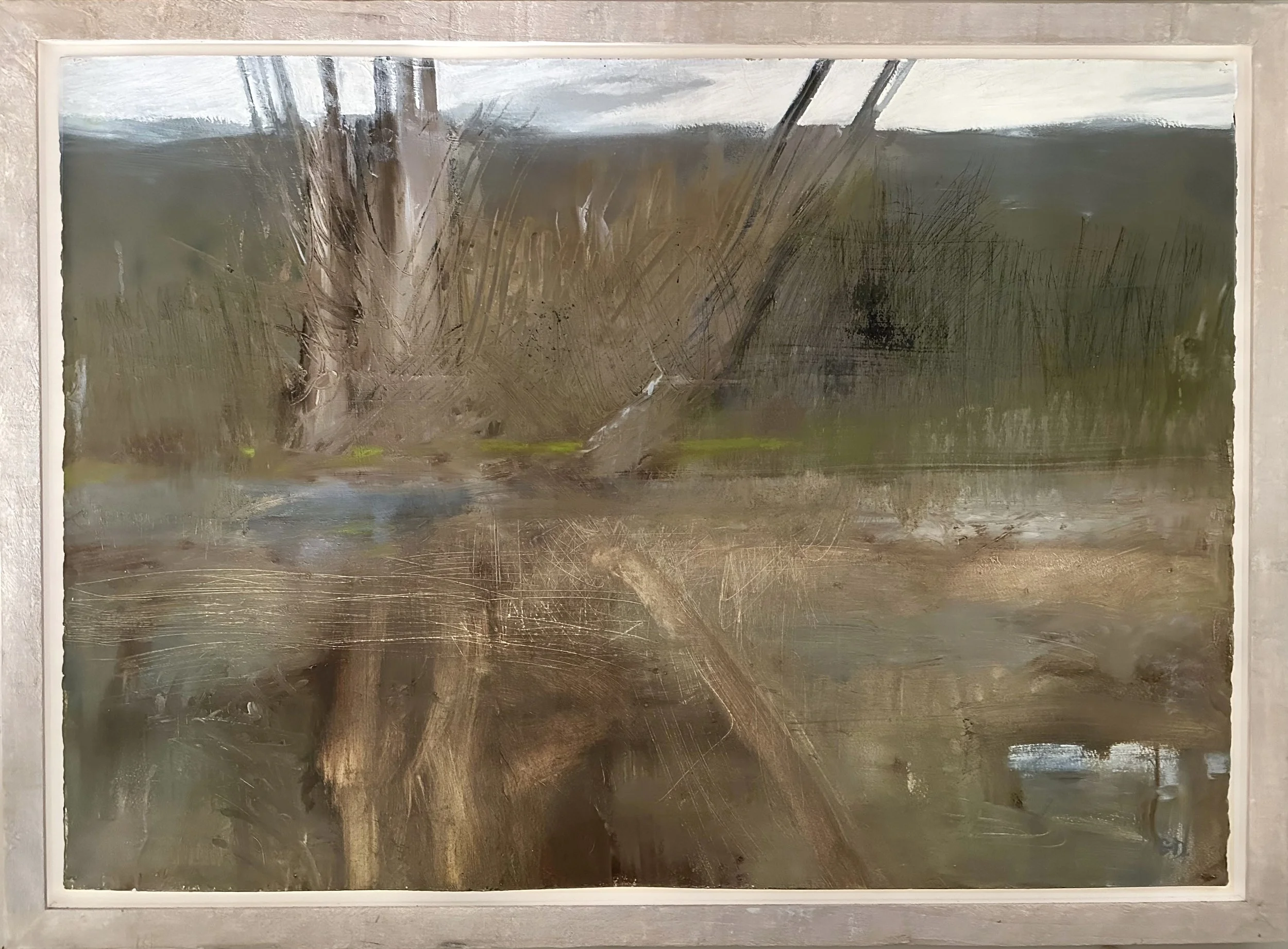 An abstract landscape painting with muted earthy tones, depicting a large tree with textured bark and sparse branches, set against a cloudy sky and hilly background, framed in white.