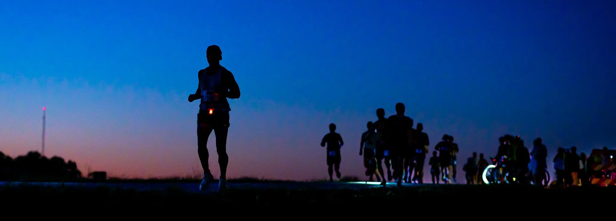 A photo of runner running at night