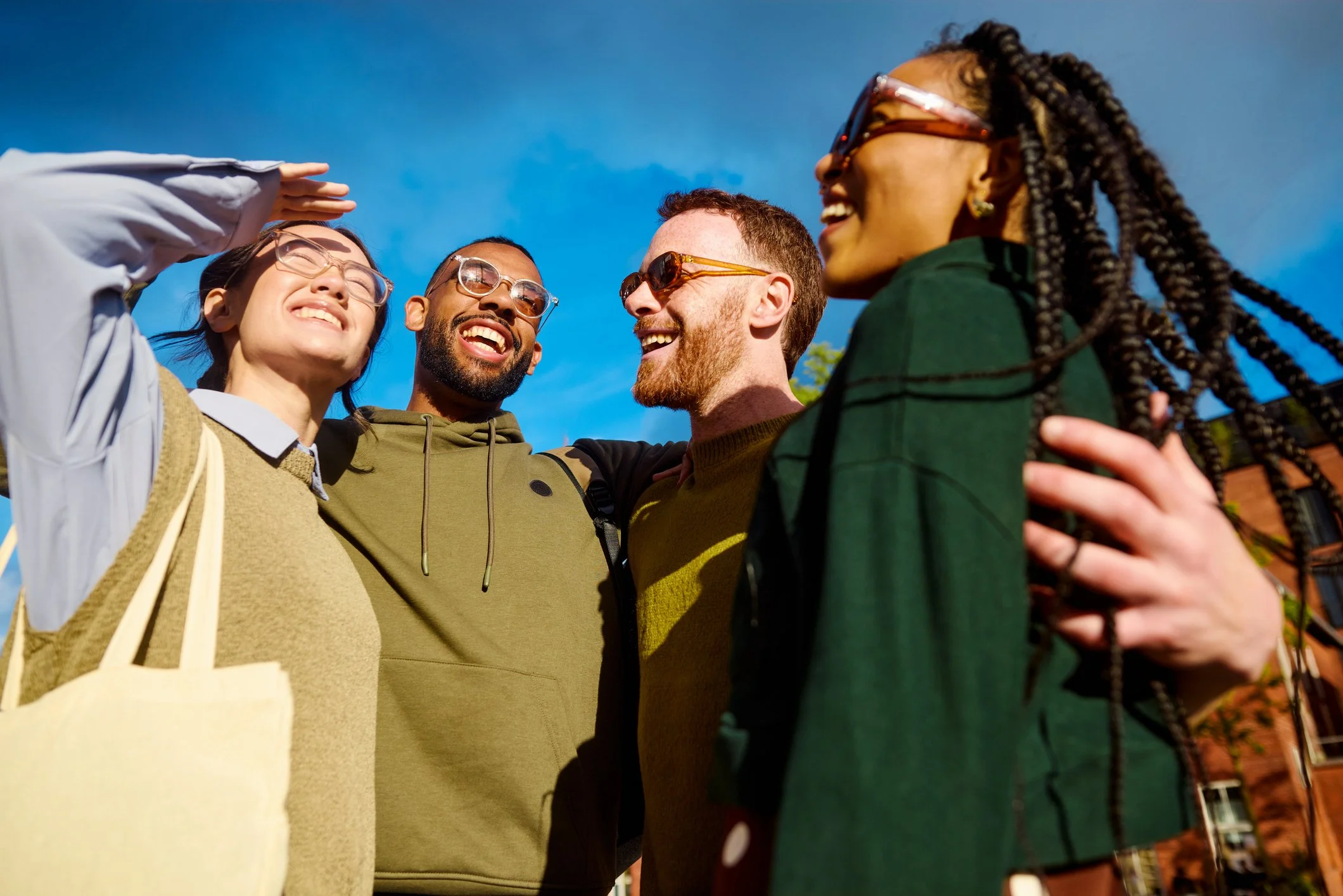 group of young adults embracing and sharing laughter