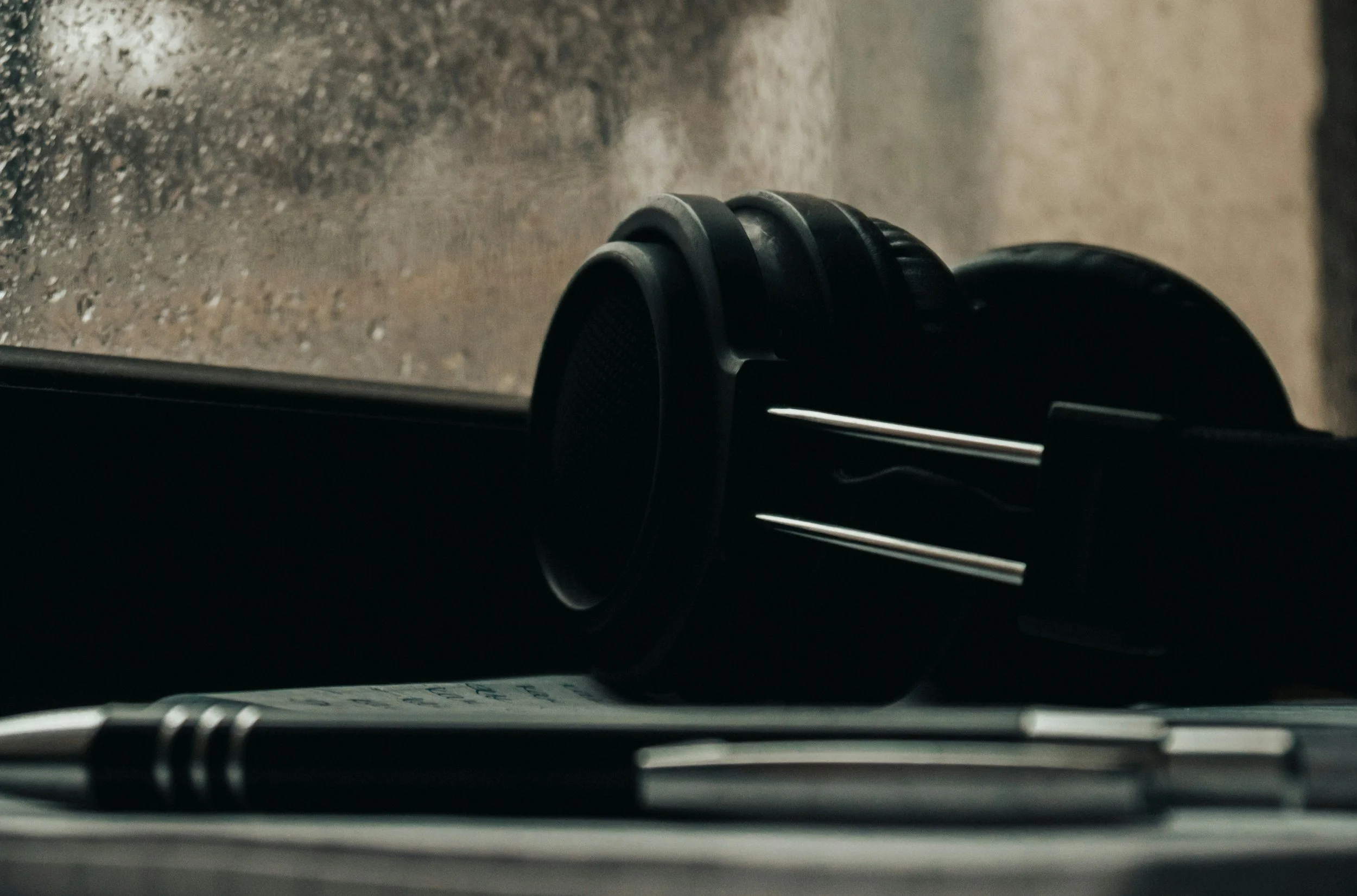 Headphones resting on a windowsill representing the safe and personal space therapy offers teens in Washington and Arizona